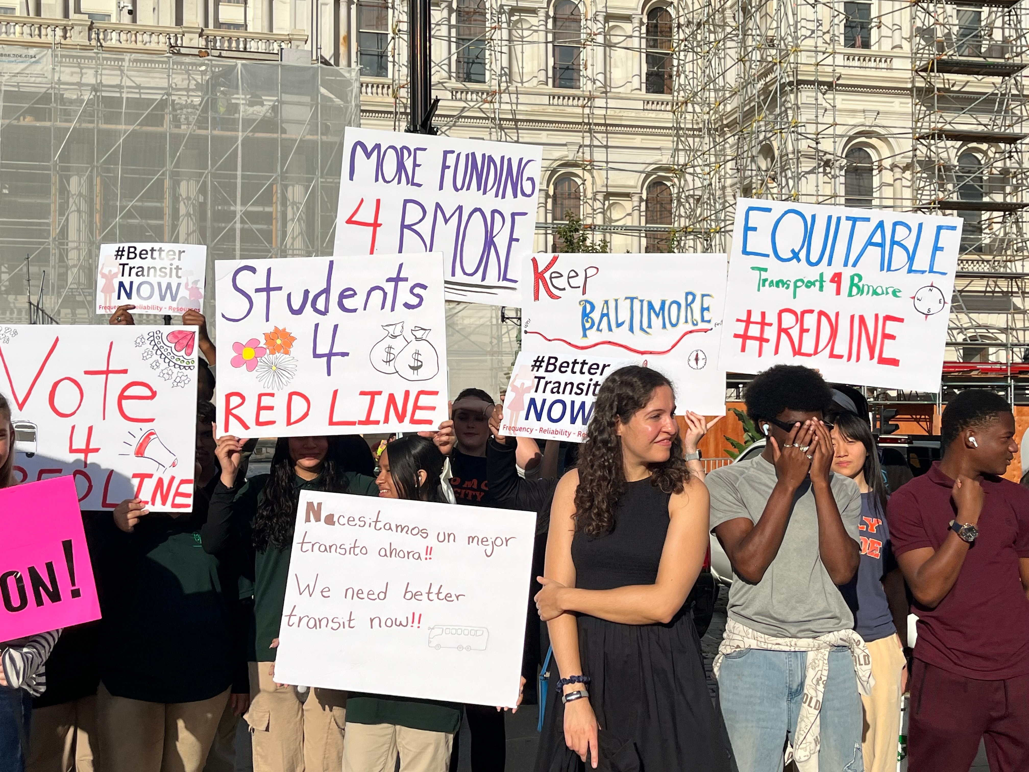 Students and adults rally in front of Baltimore City Hall asking for additional funds to be allocated to Baltimore public transit as MDOT officials share their proposed transportation plan on Wednesday.