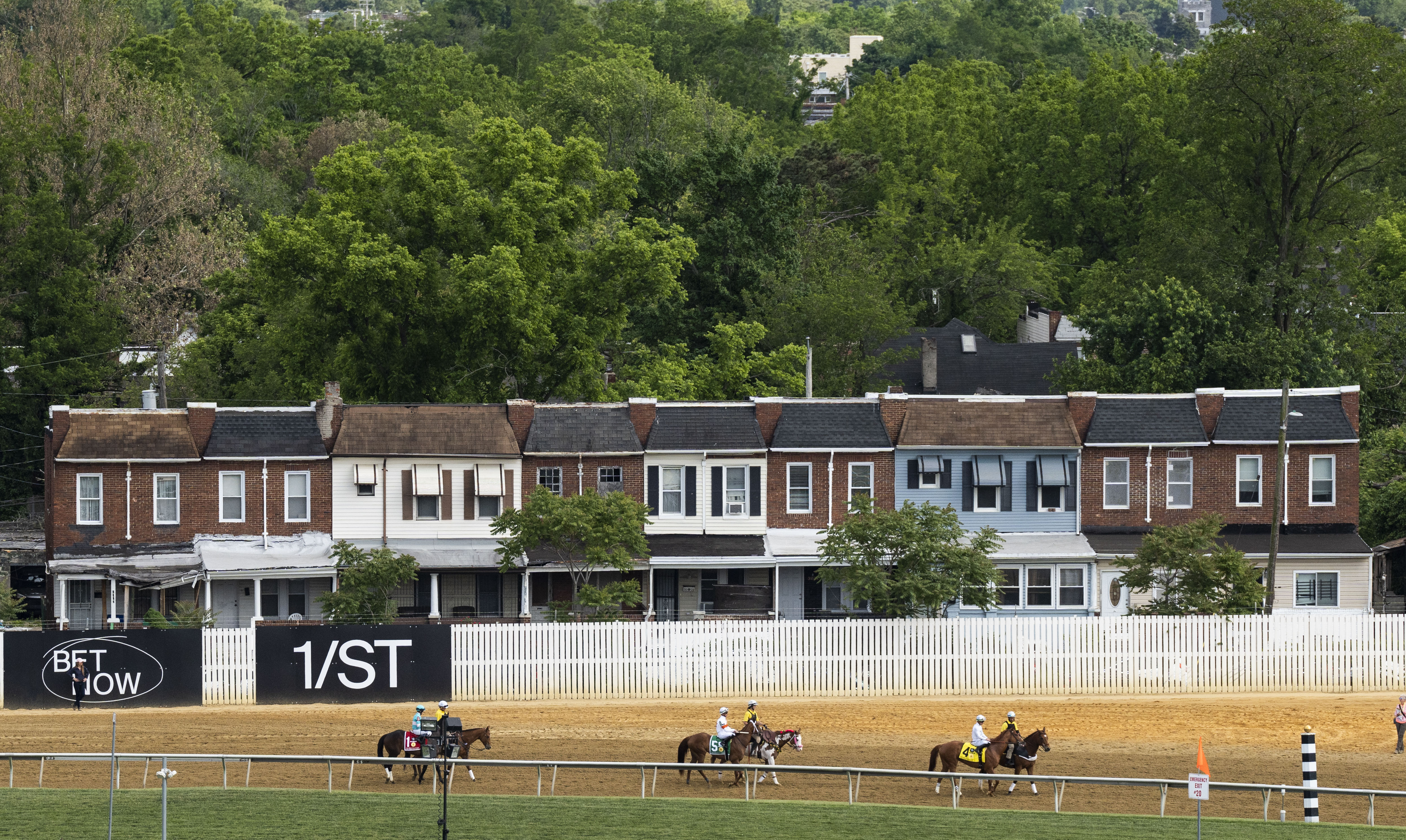 Horses and their handlers prepare to ride during the George E. Mitchell Black-Eyed Susan Stakes at Pimlico on May 19, 2023. 