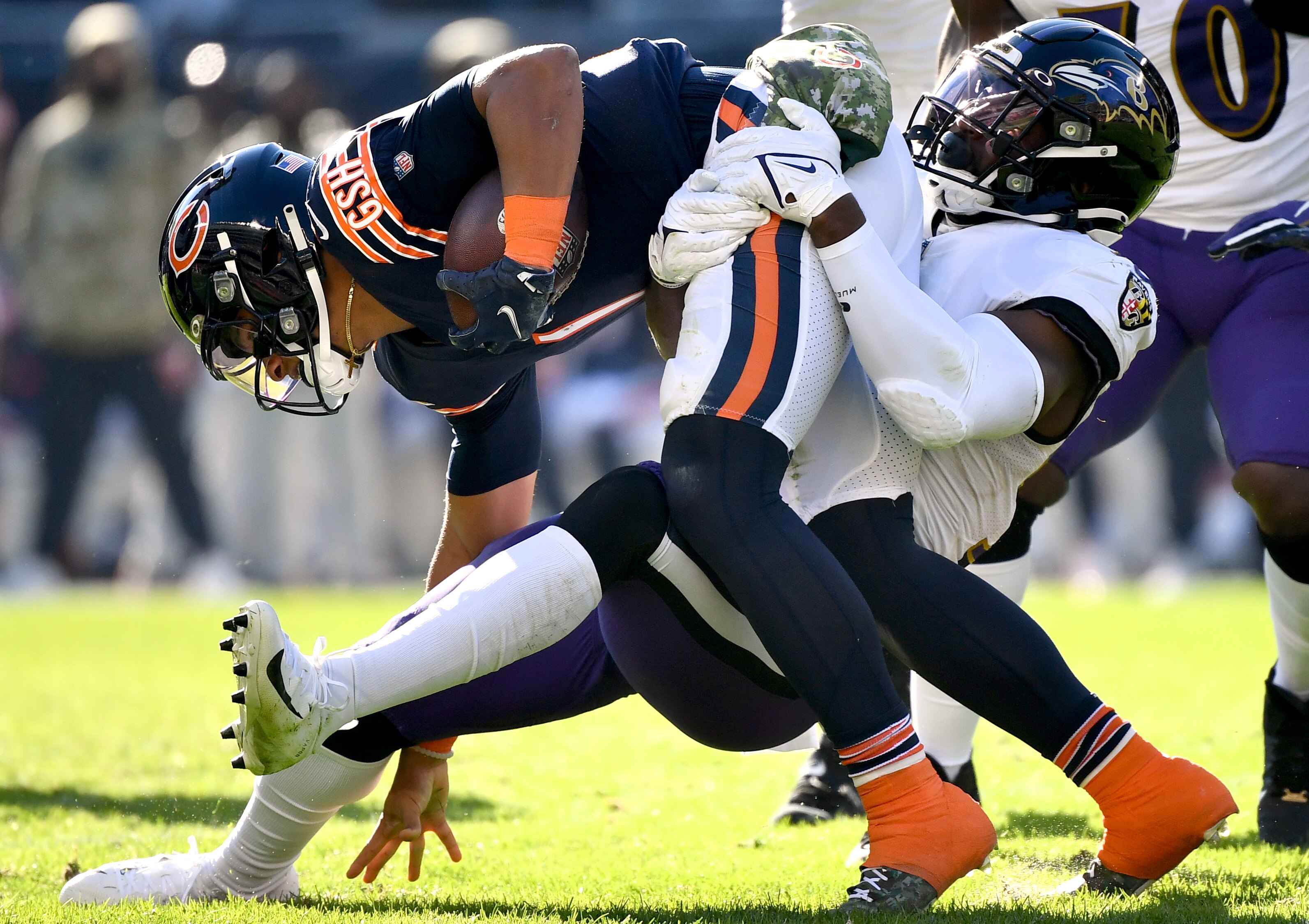 Justin Fields, #1 of the Chicago Bears, is tackled by Tyus Bowser, #54 of the Baltimore Ravens, during the second quarter at Soldier Field on Nov. 21, 2021 in Chicago, Illinois.