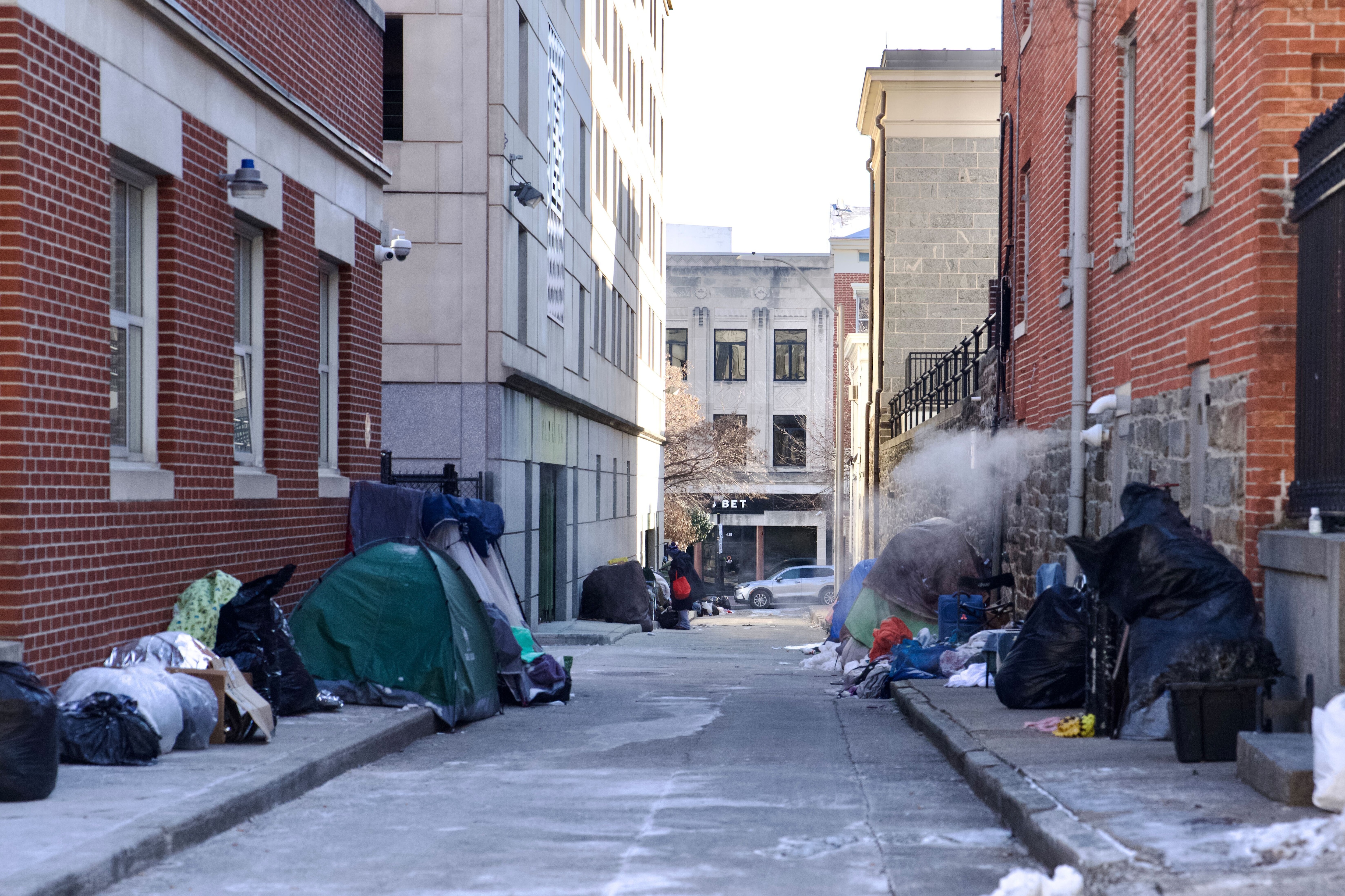 Tents and personal items in an alley in Mount Vernon, Baltimore, on Wednesday, January 22, 2025. Baltimore activated its cold weather winter shelter initiative on Friday in response to the frigid weather. The designation, which will not expire until Thursday, expands the city’s shelter options for the homeless.