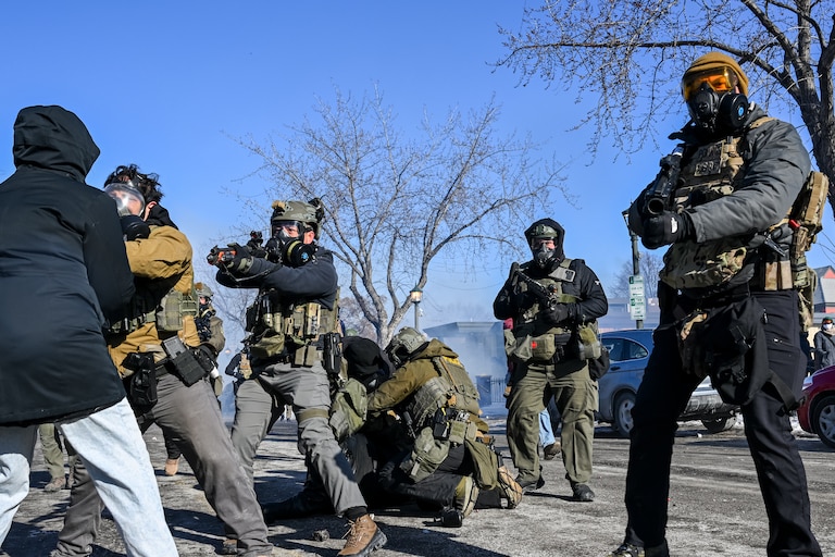 A person is tackled by a federal agent amid protests following a shooting on January 24, 2026 in Minneapolis, Minnesota. Federal agents shot and killed a protestor amid a scuffle to arrest him. The Trump administration has sent a reported 3,000 federal agents into the area, with more on the way, as they make a push to arrest undocumented immigrants in the region.