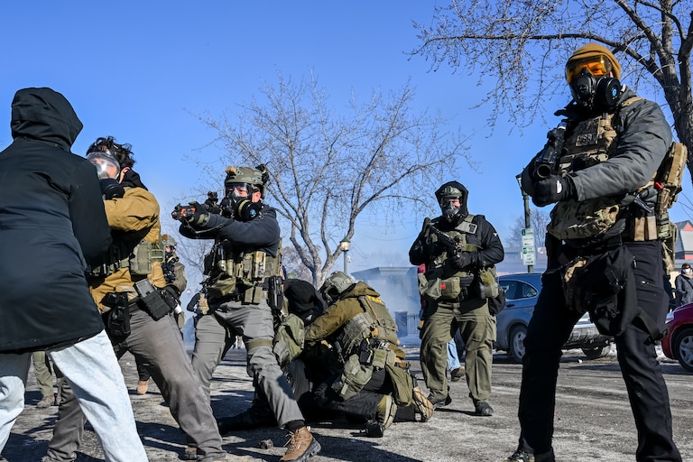 A person is tackled by a federal agent amid protests following a shooting on January 24, 2026 in Minneapolis, Minnesota. Federal agents shot and killed a protestor amid a scuffle to arrest him. The Trump administration has sent a reported 3,000 federal agents into the area, with more on the way, as they make a push to arrest undocumented immigrants in the region.