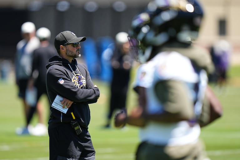 Baltimore Ravens head coach Jesse Minter walks on the field during the team's NFL football practice, Tuesday, June 2, 2026, at the Under Armour Performance Center in Owings Mills, Md.