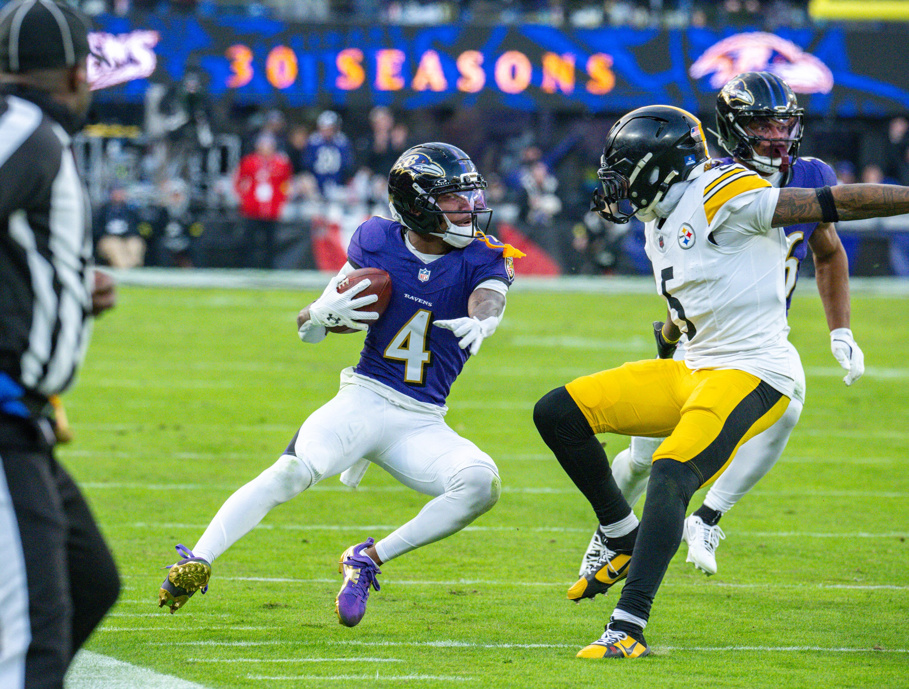 Ravens wide receiver Zay Flowers picks up a first down on a fourth-quarter reception against the Steelers in the first meeting between the teams this season.
