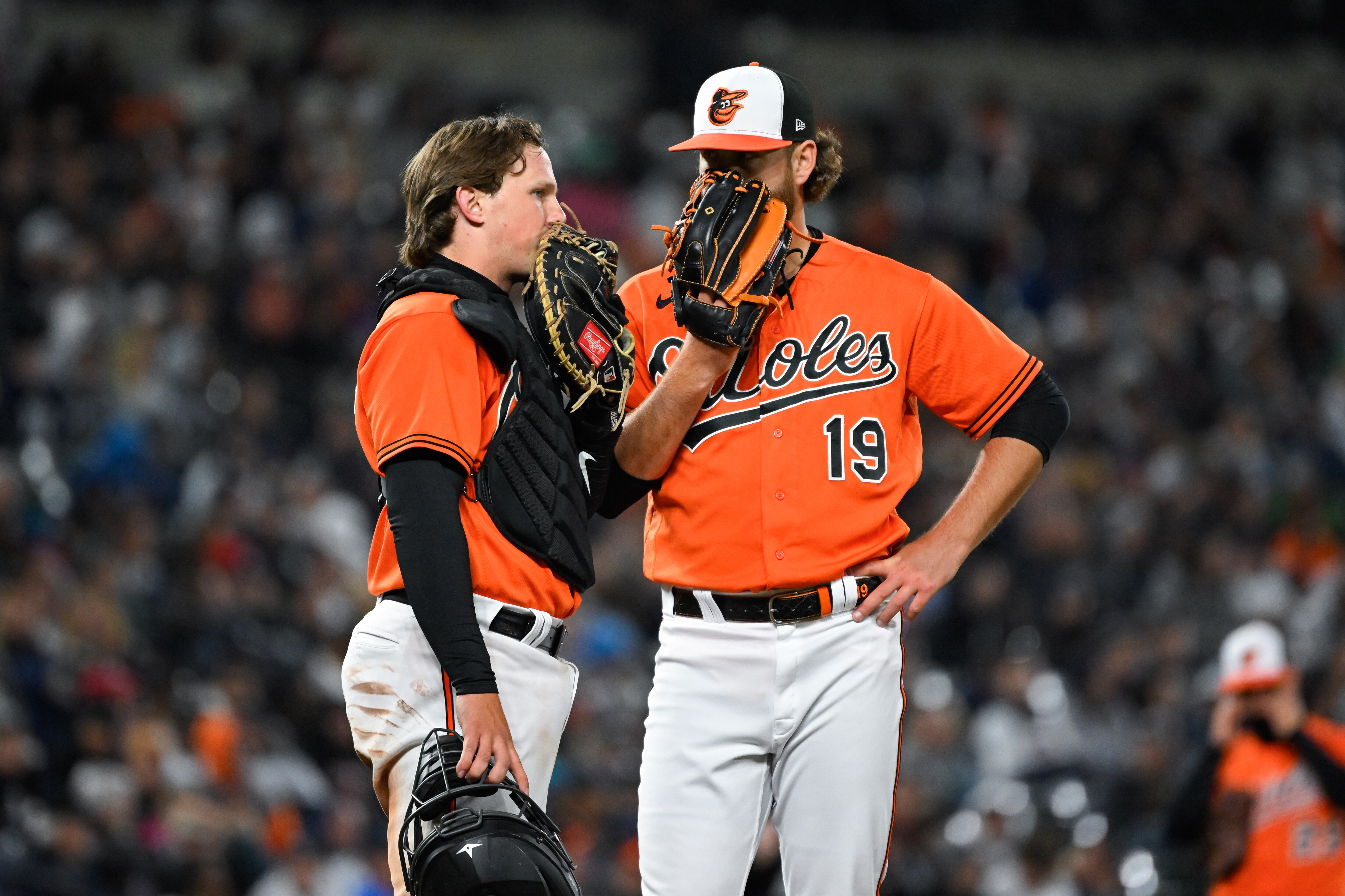 Baltimore Orioles catcher Adley Rutschman meets with starting pitcher Cole Irvin (19) on the mound during the fourth inning of an baseball game against the New York Yankees, Friday, April 7, 2023, in Baltimore.