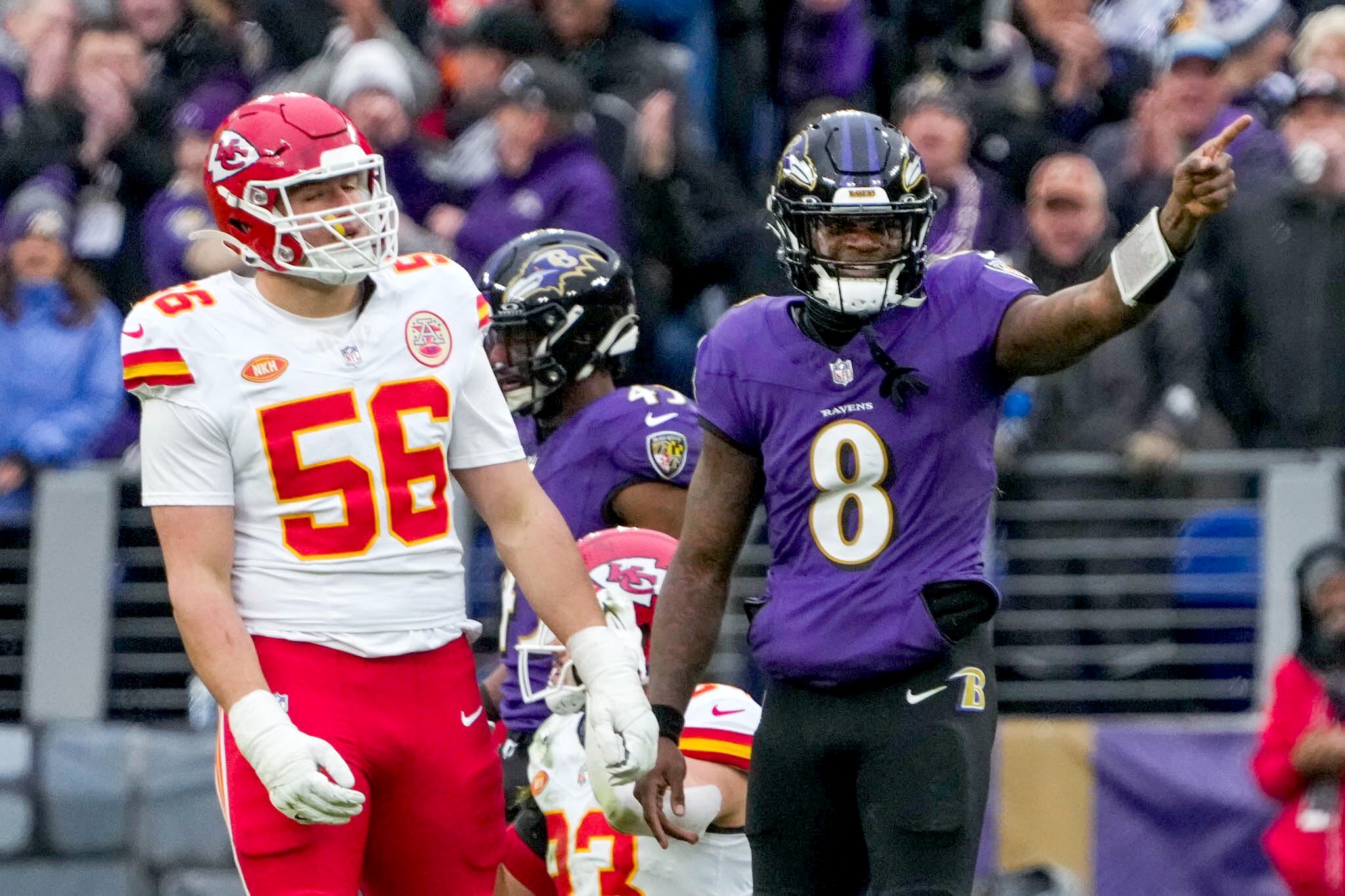 Ravens quarterback Lamar Jackson signals for a first down after he caught his own deflected pass and turned it into a 13-yard gain.