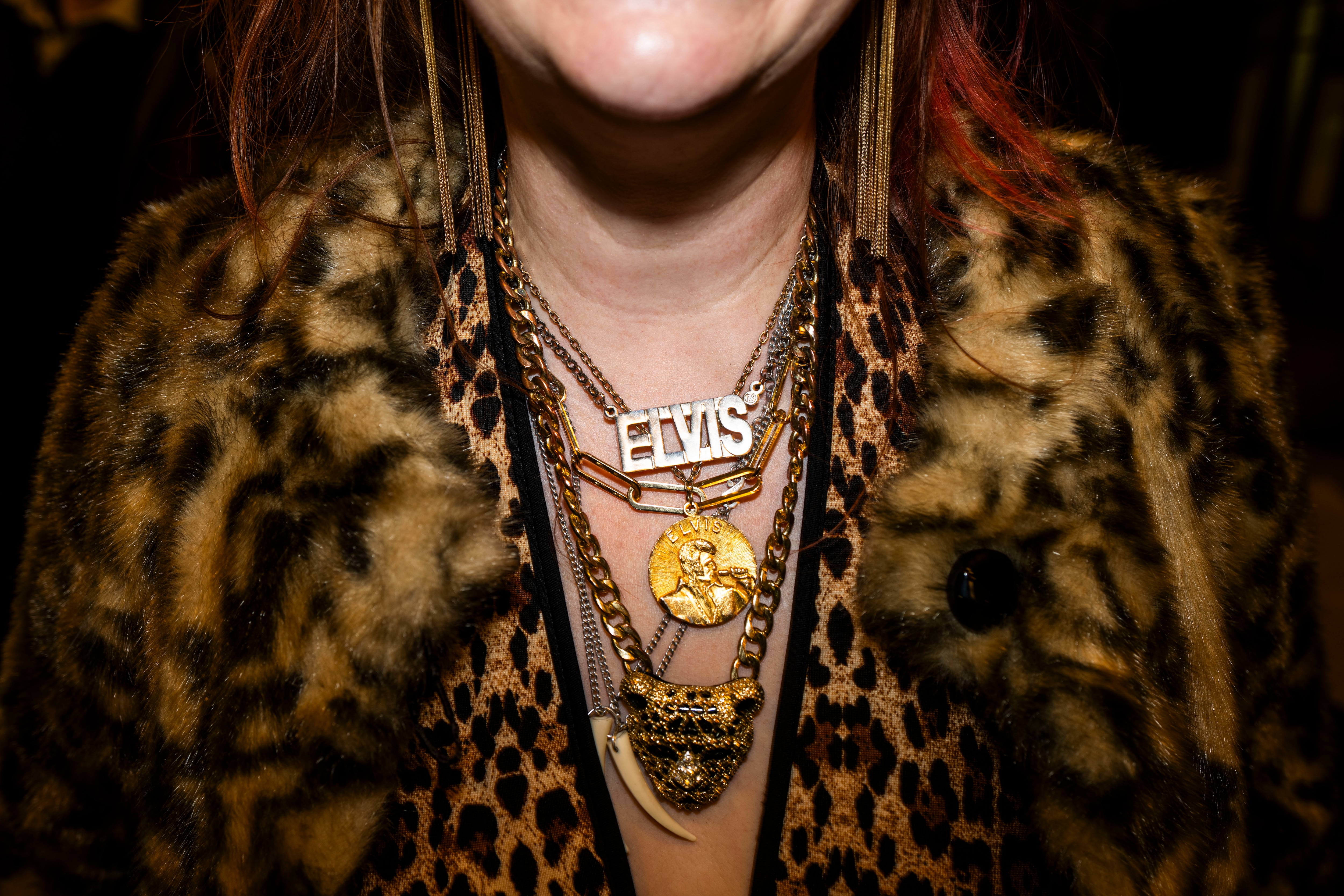 An Elvis fan wears his name around their neck during the performances