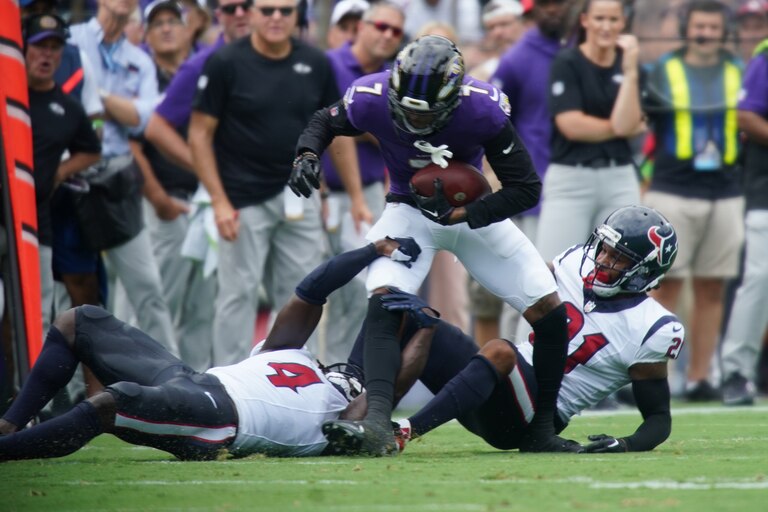 Baltimore Ravens wide receiver Rashod Bateman (7) steps out of the grasp of Texans #4 Tavierre Thomas in the season opening game at M&T Stadium.