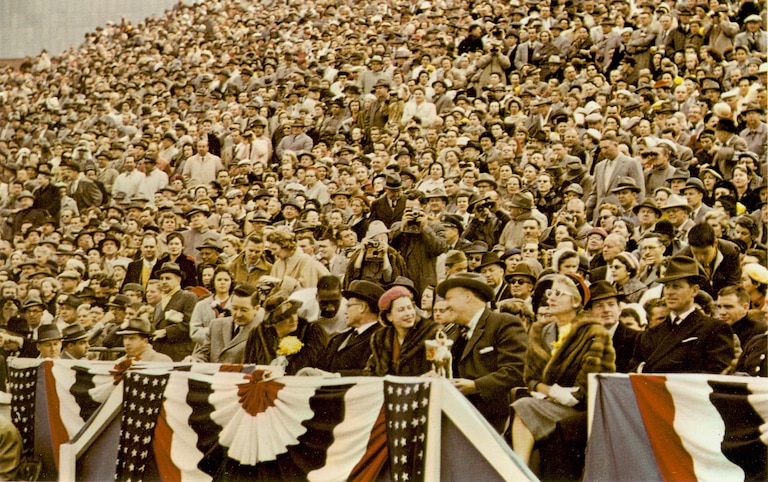 A color photograph from the Terrapin yearbook of Queen Elizabeth sitting in the stands watching a Maryland football game, 1957. Courtesy of University of Maryland Archives.