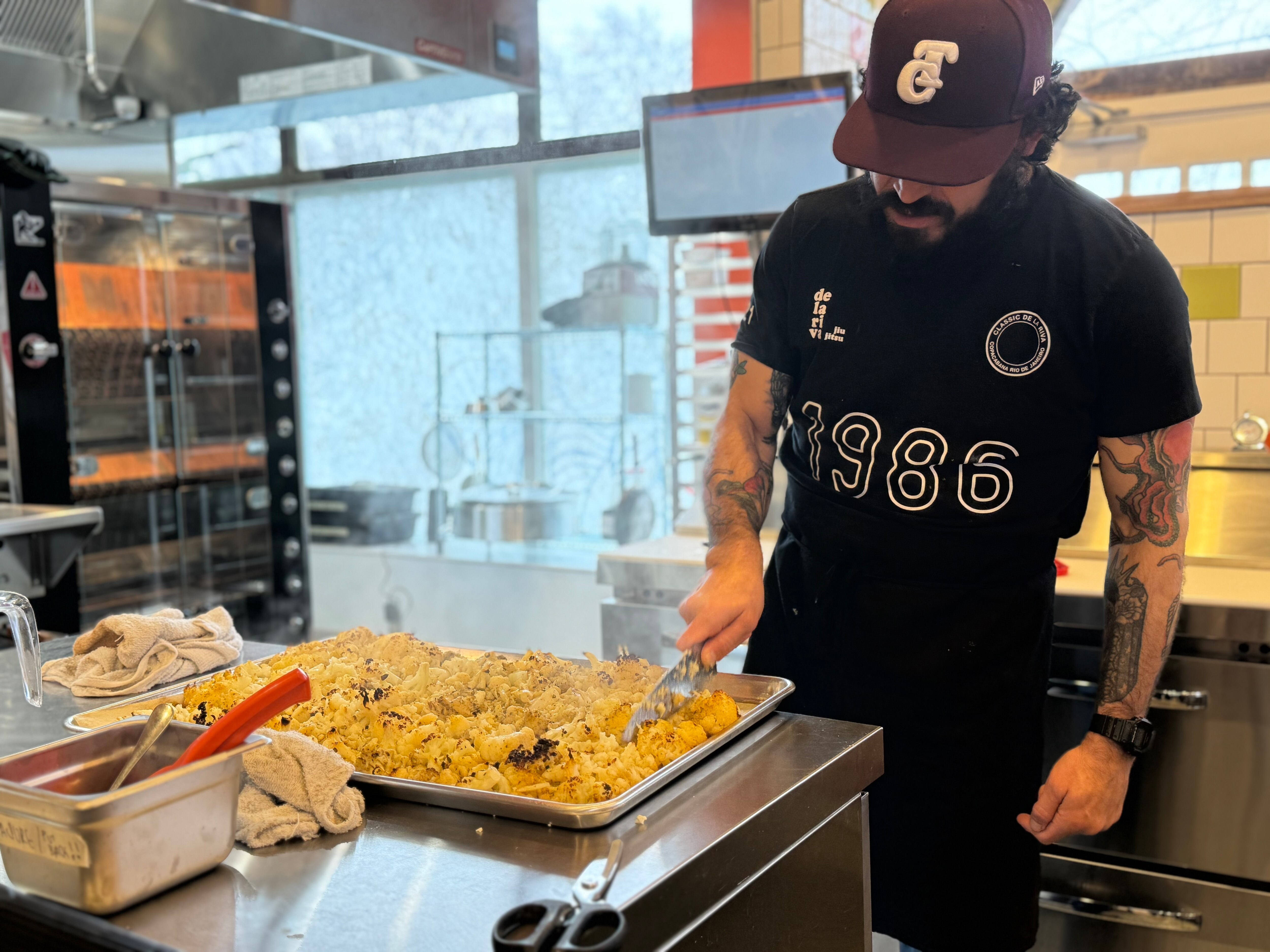 Carlos Raba chops roasted cauliflower for Nana’s vegan tacos.