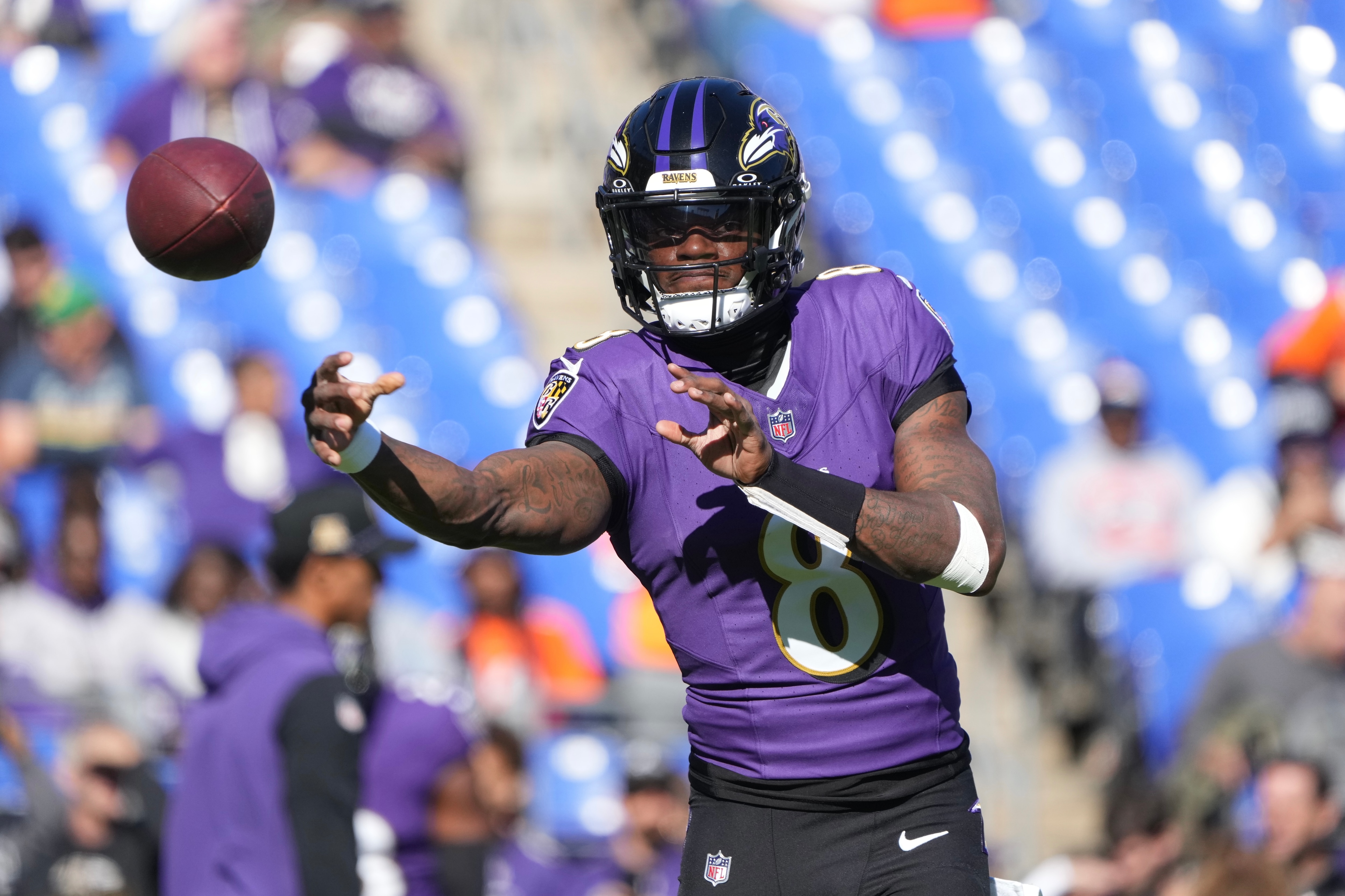 Ravens quarterback Lamar Jackson throws a pass while warming up before the game against the Denver Broncos last Sunday.