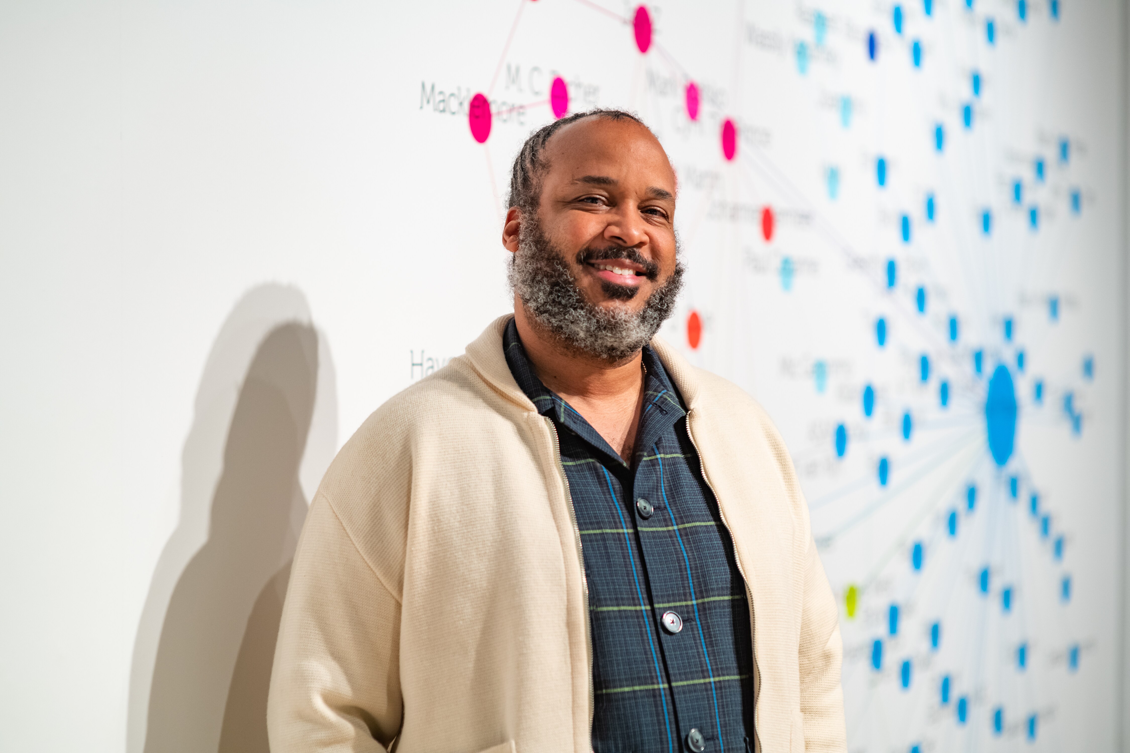 Tahir Hemphill takes a portrait in his exhibition focused on his many multimedia works, and data visualization in his gallery space at UMBC in Baltimore, Md., on February 2, 2023.