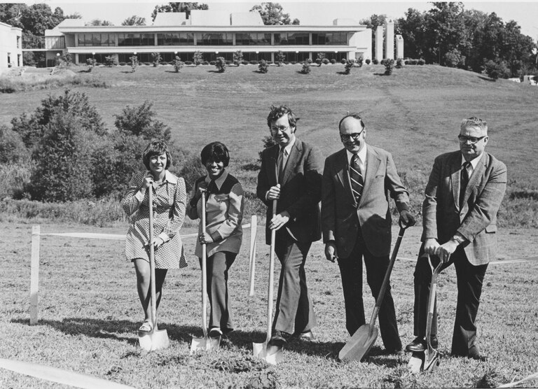 Edward Cochran, fourth from left, then Howard County Executive, plants a shovel in the ground at the Howard Community College groundbreaking for the physical education complex.