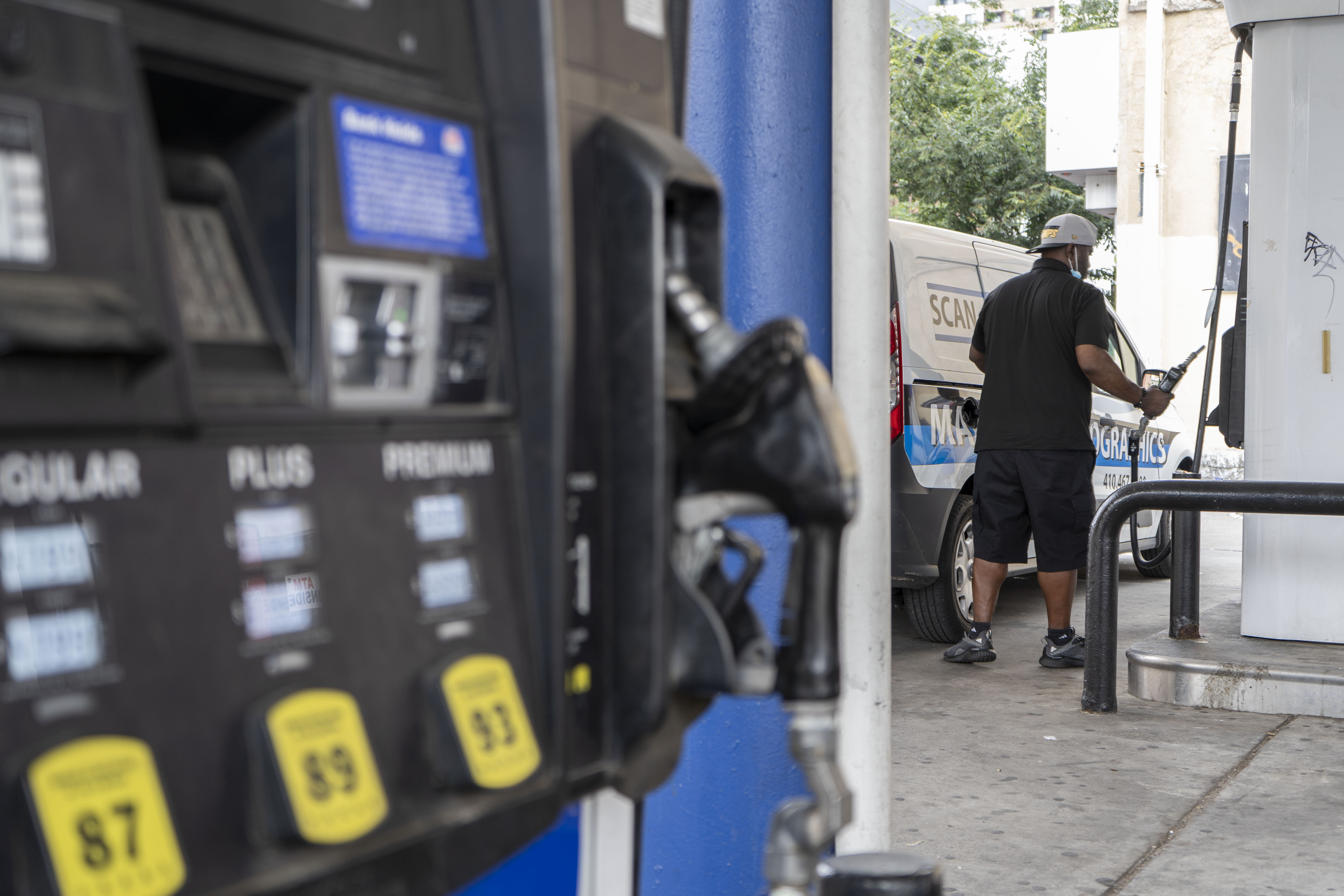 A person pumps gas at a Marathon gas station on North Charles Street.