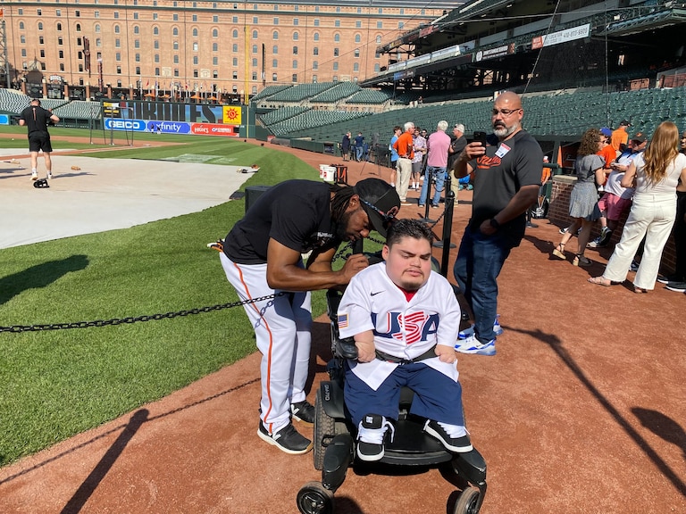 Orioles outfielder Cedric Mullins signs the back of A.J. Rodriguez's jersey.