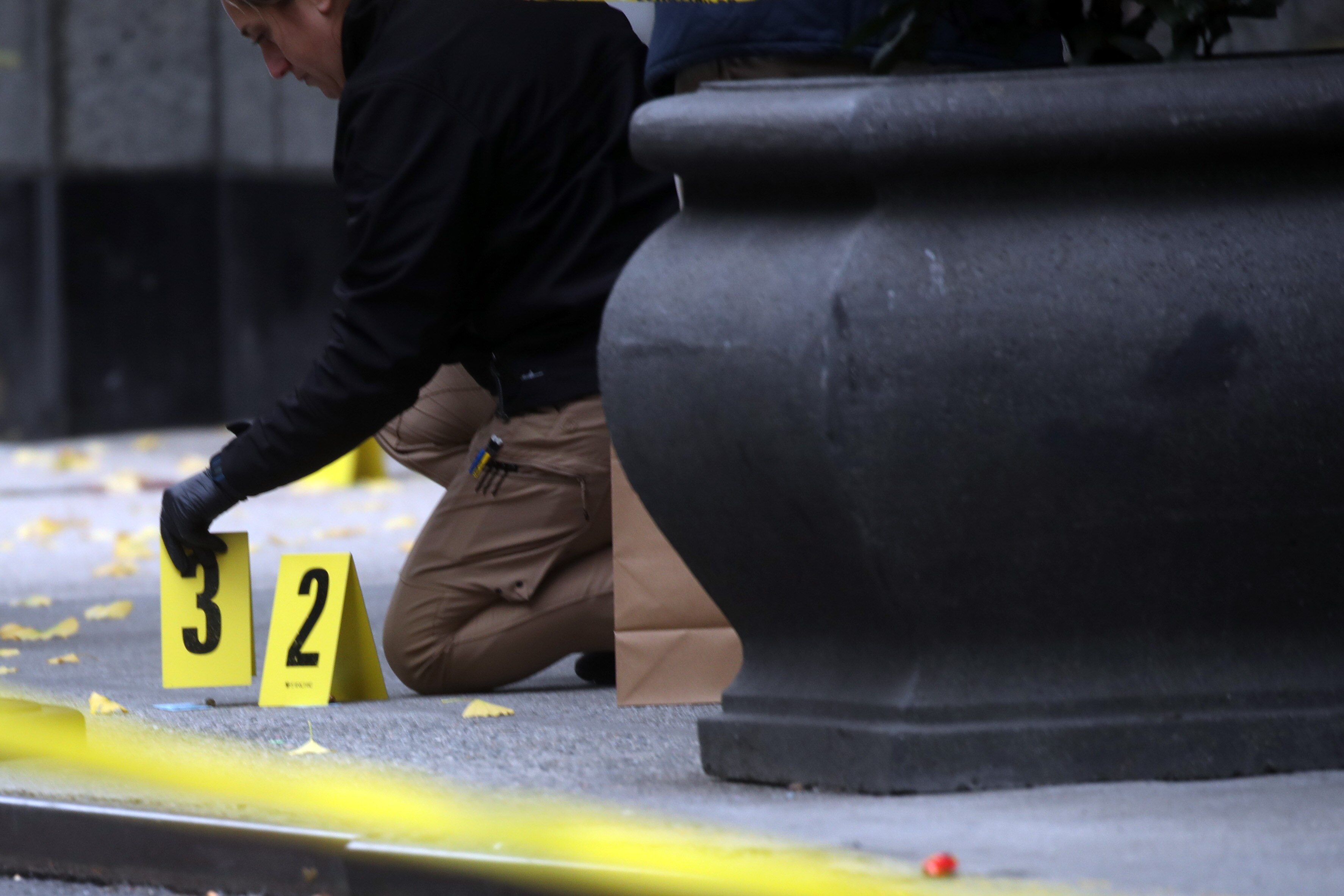 Police place bullet casing markers outside of a Hilton Hotel in Midtown Manhattan where UnitedHealthcare CEO Brian Thompson was fatally shot on December 4.