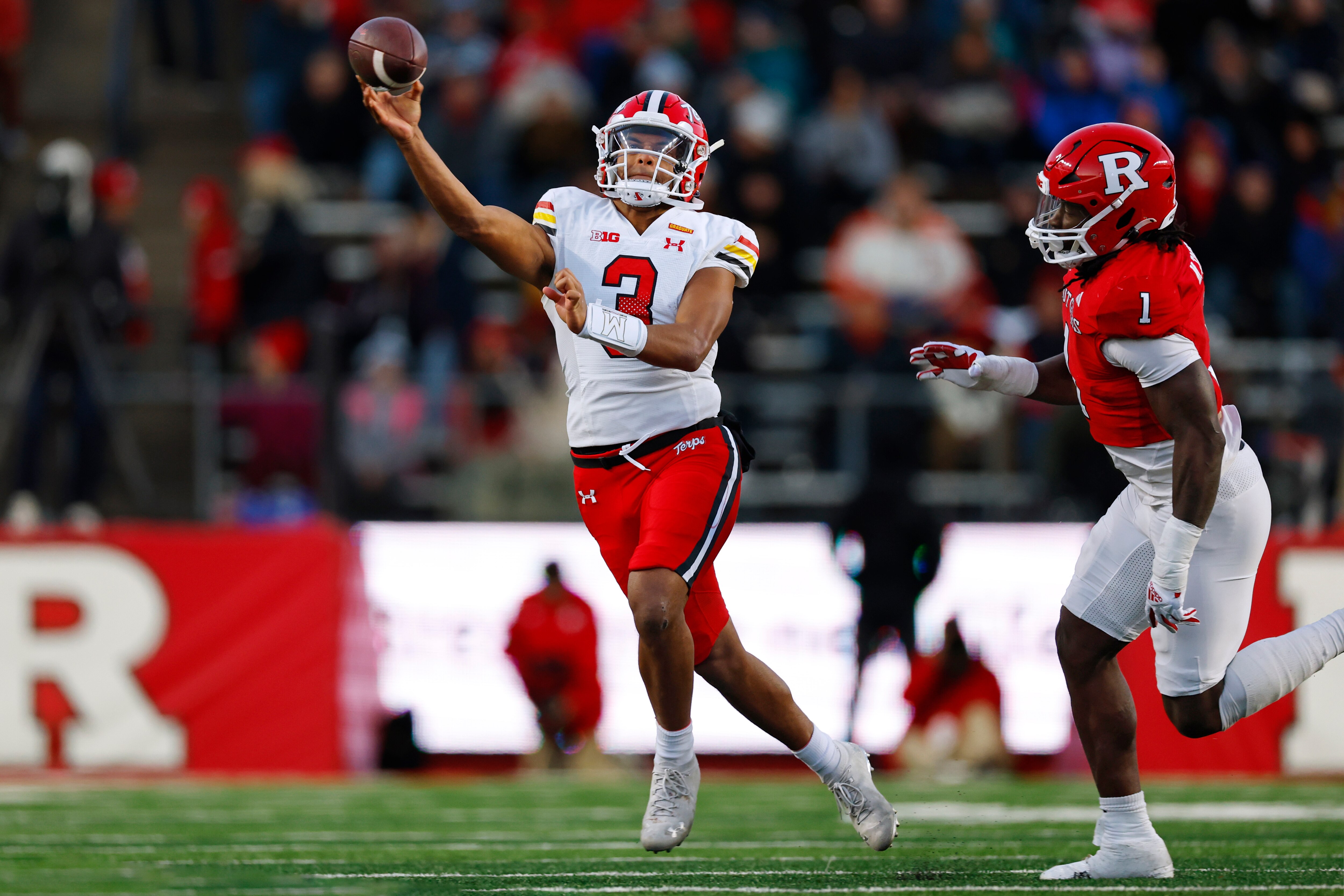 Maryland's Taulia Tagovailoa passes as linebacker Mohamed Toure of Rutgers pursues during the first quarter Saturday in New Jersey.