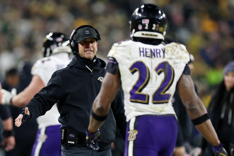 GREEN BAY, WISCONSIN - DECEMBER 27: Derrick Henry #22 and head coach John Harbaugh of the Baltimore Ravens celebrate after scoring a touchdown in the second quarter against the Green Bay Packers at Lambeau Field on December 27, 2025 in Green Bay, Wisconsin. (Photo by Michael Reaves/Getty Images)
