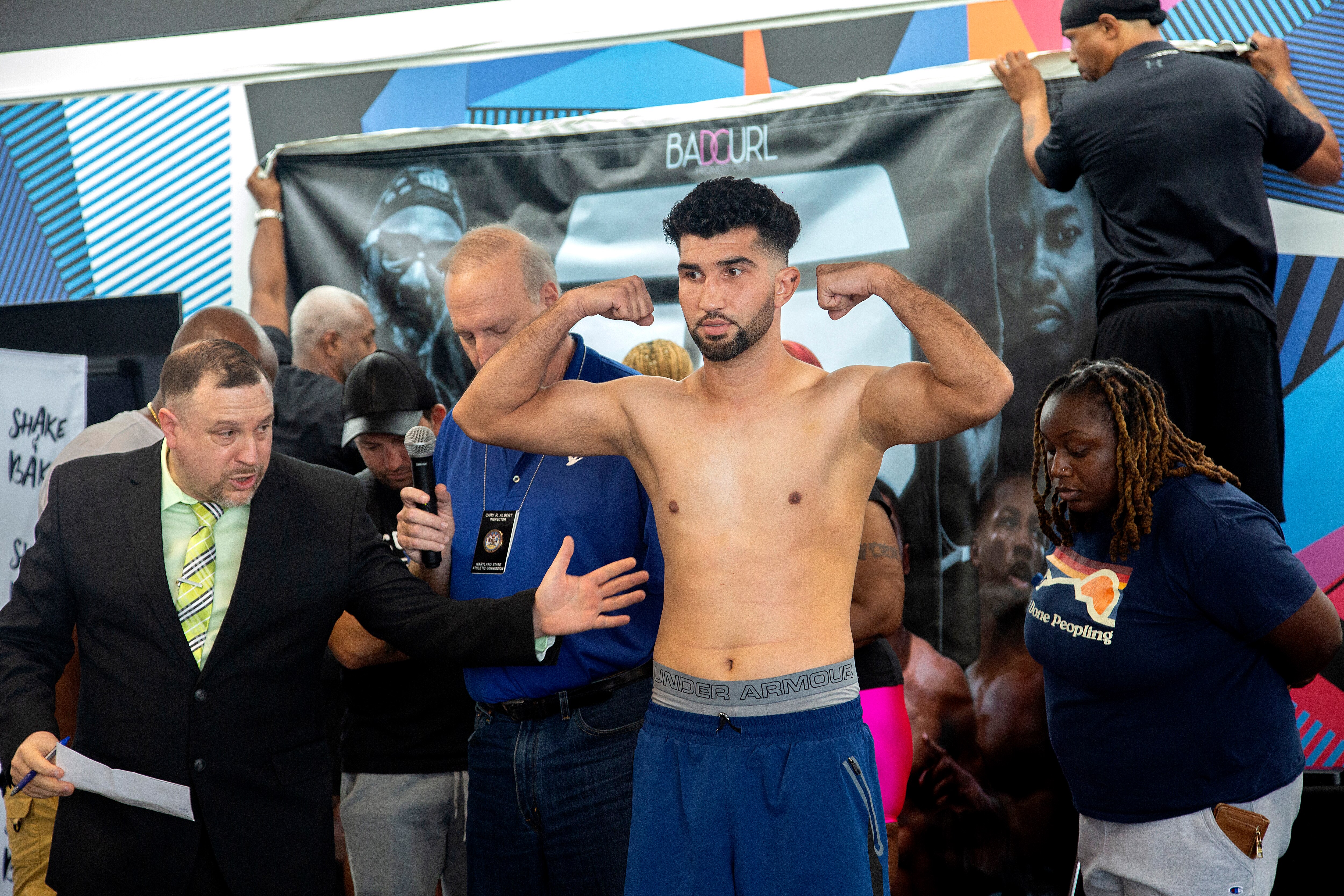Rafiullah Yari weighs in against his opponent Christopher Wright of Georgia at Coppin State University.