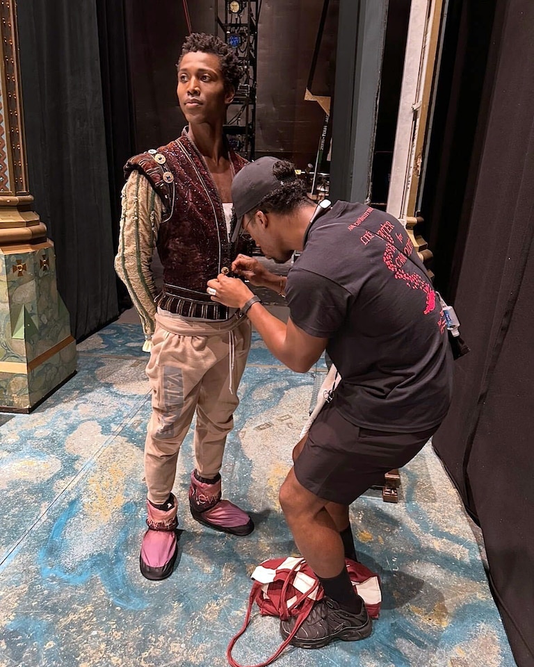 Dante Baylor works on production for Alvin Ailey theater shows, tailoring costumes and setting the stage for performers.