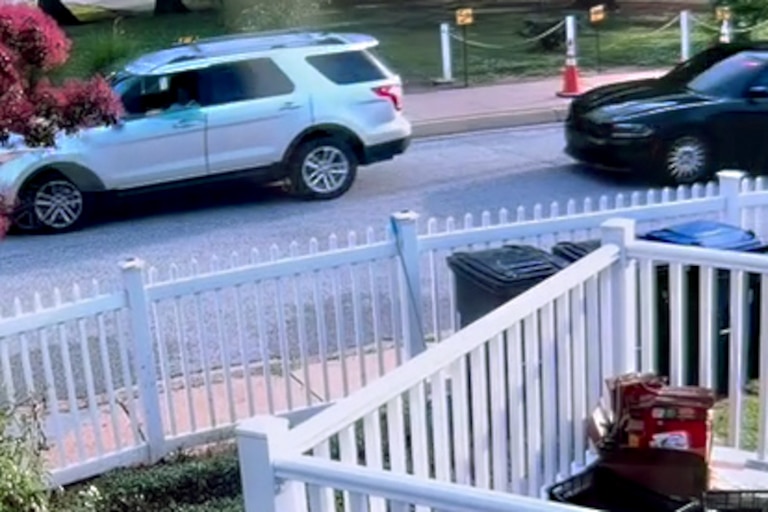A still from home security camera footage, provided by a Graceland Park resident, shows a black sedan tailing the family's silver Ford Explorer.
