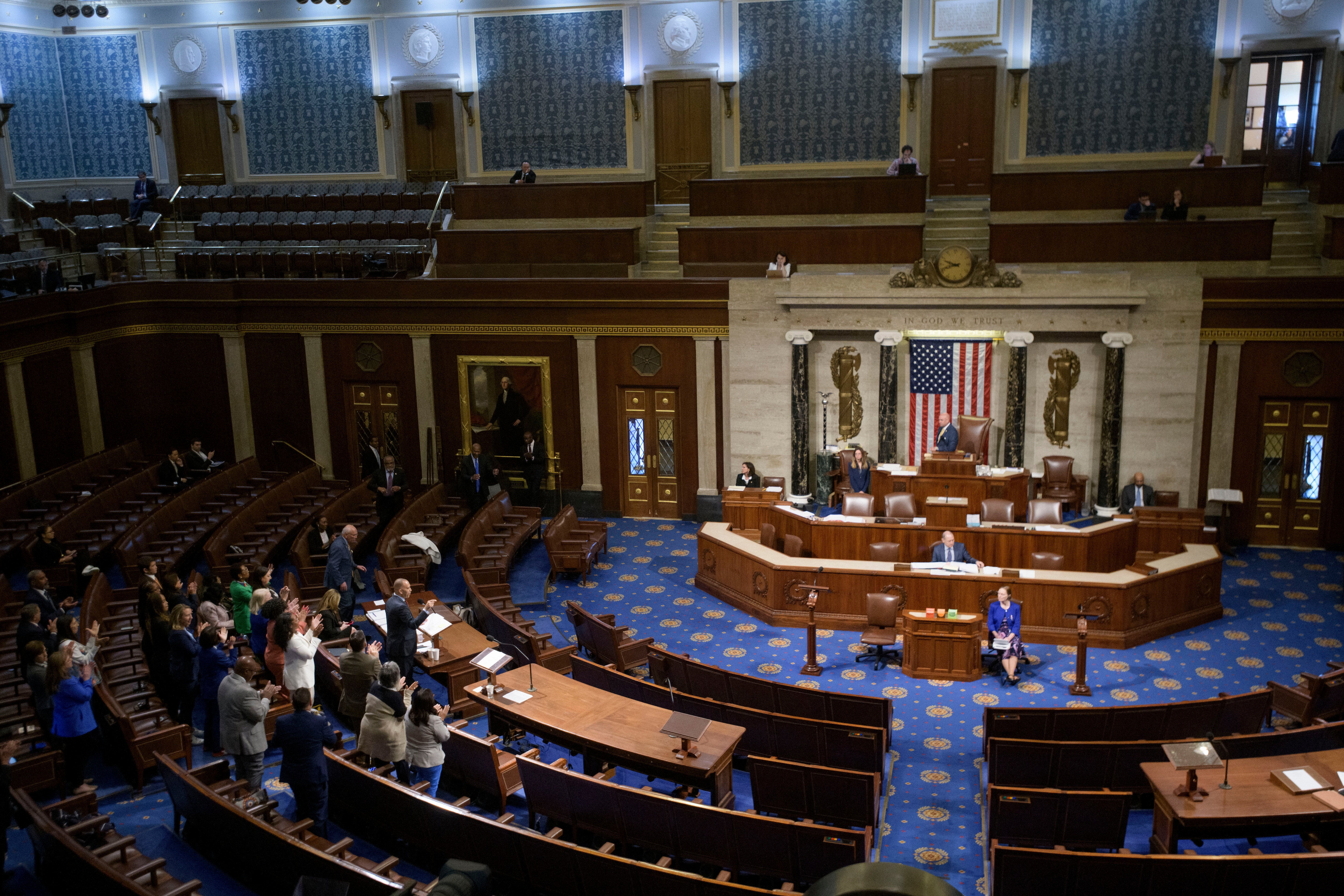 House Minority Leader Hakeem Jeffries, D-N.Y., left, speaks in the House chamber as House Democrats stand to applaud him, prior to the final vote for President Donald Trump's signature bill of tax breaks and spending cuts, at the Capitol, Thursday, July 3, 2025, in Washington. (AP Photo/Rod Lamkey, Jr.)