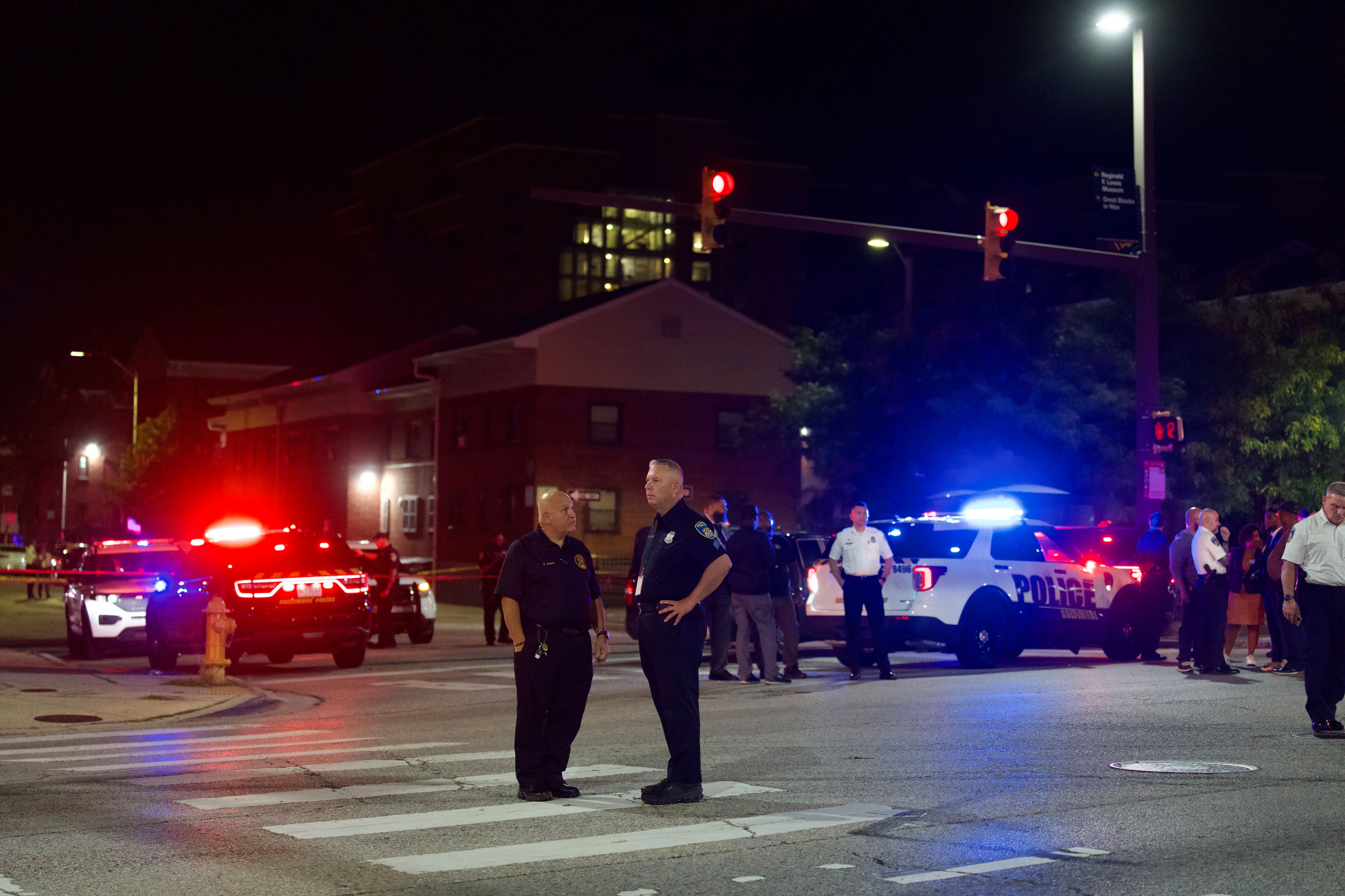 Police officers investigate the intersection of North Caroline and Fayette streets following a shooting on Wednesday evening. 