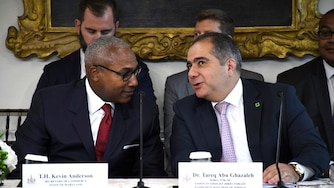 Maryland Secretary of Commerce Kevin Anderson talks with Tareq Abu Ghazaleh, director of vision oversight for the directorate of Jordan.