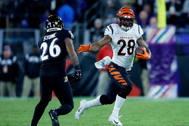 BALTIMORE, MARYLAND - OCTOBER 09: Joe Mixon #28 of the Cincinnati Bengals rushes against Geno Stone #26 of the Baltimore Ravens in the fourth quarter at M&T Bank Stadium on October 09, 2022 in Baltimore, Maryland.