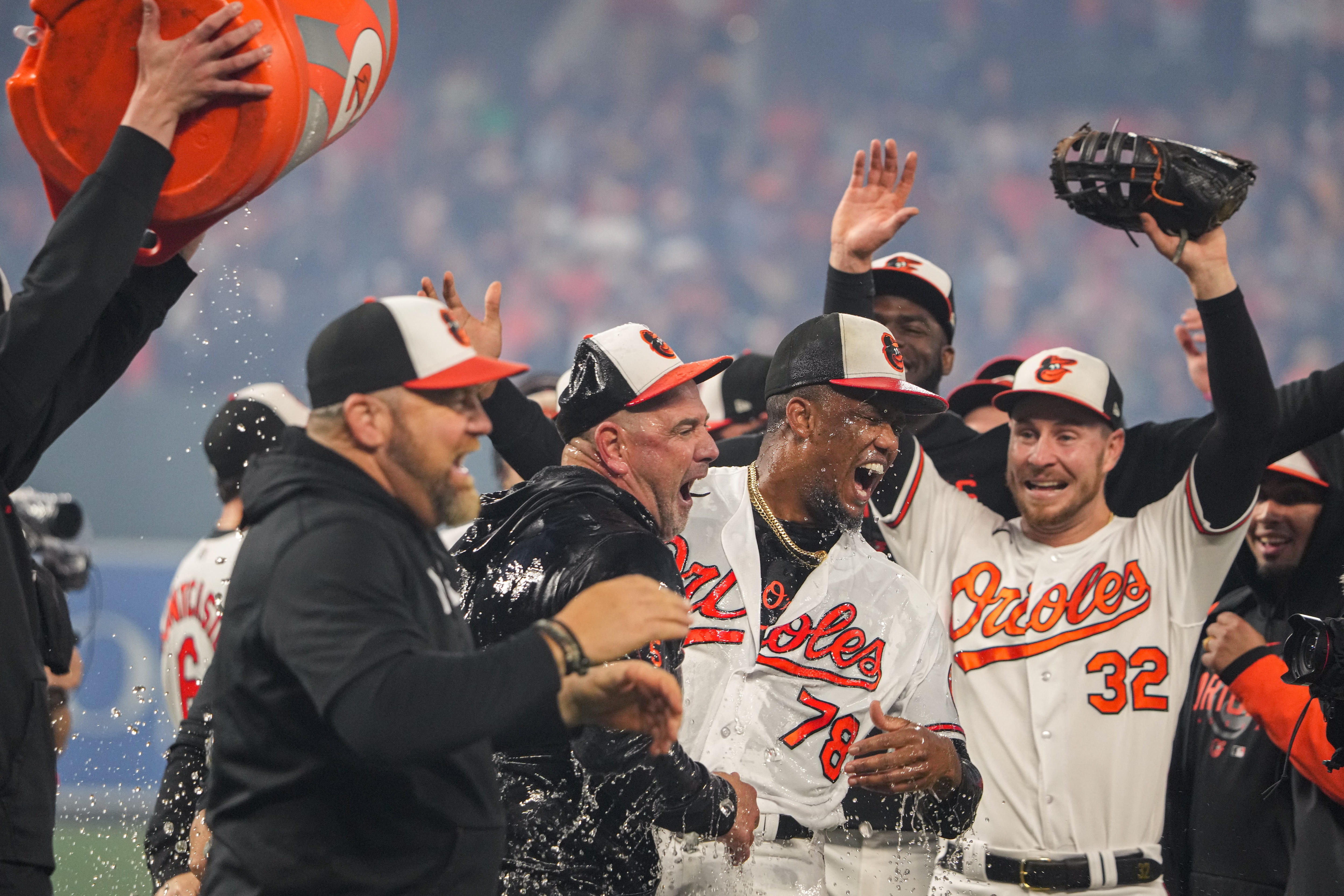 Baltimore Orioles manager Brandon Hyde and relief pitcher Yennier Cano (78) are doused by teammates after beating the Boston Red Sox on Thursday, September 28, 2023, securing a division title for the team for the first time since 2014.