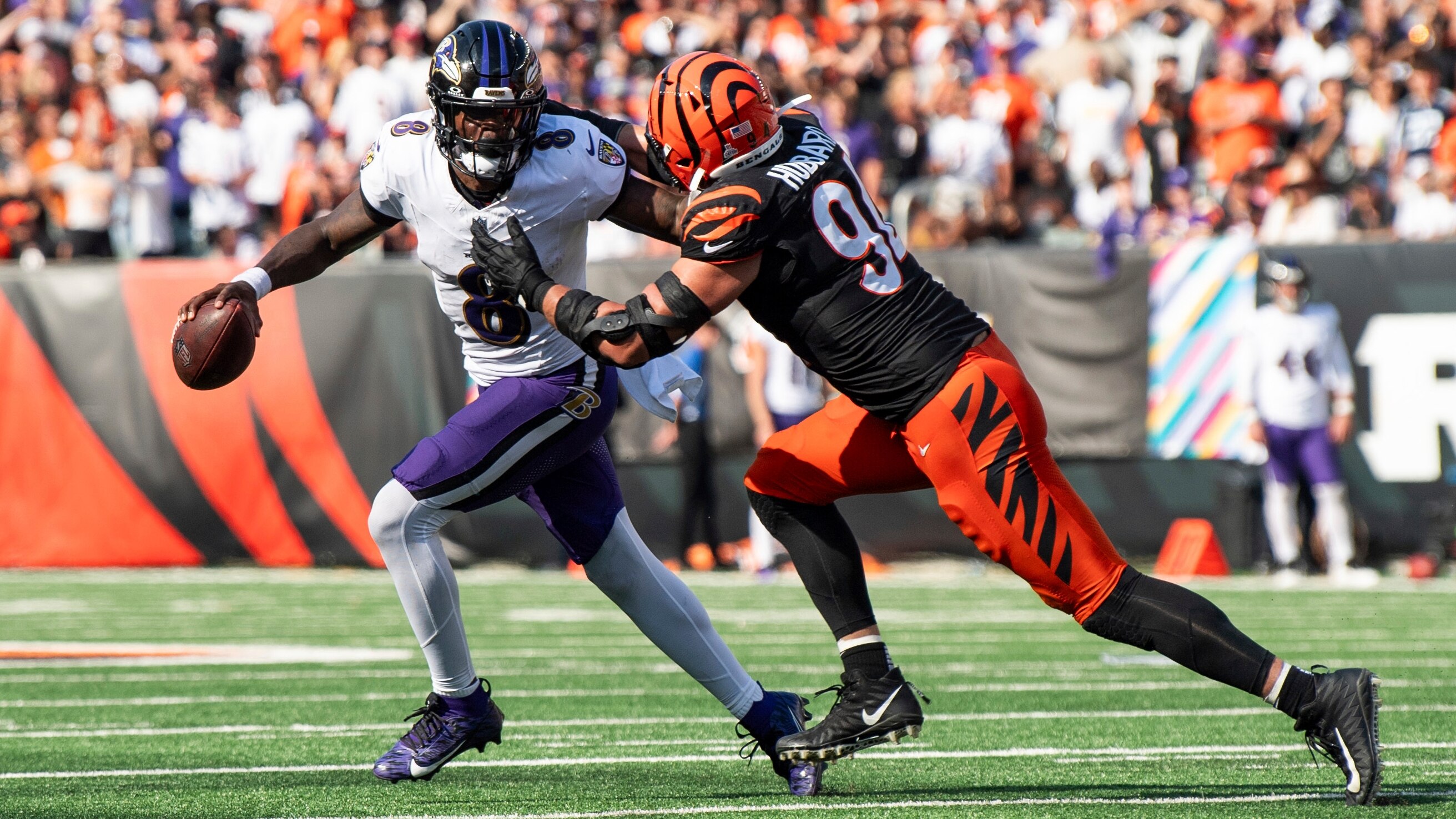 Baltimore Ravens quarterback Lamar Jackson (8) carries the ball against Cincinnati Bengals defensive end Sam Hubbard (94) in the second half during an NFL football game on Sunday, Oct. 6, 2024, in Cincinnati. (AP Photo/Emilee Chinn)