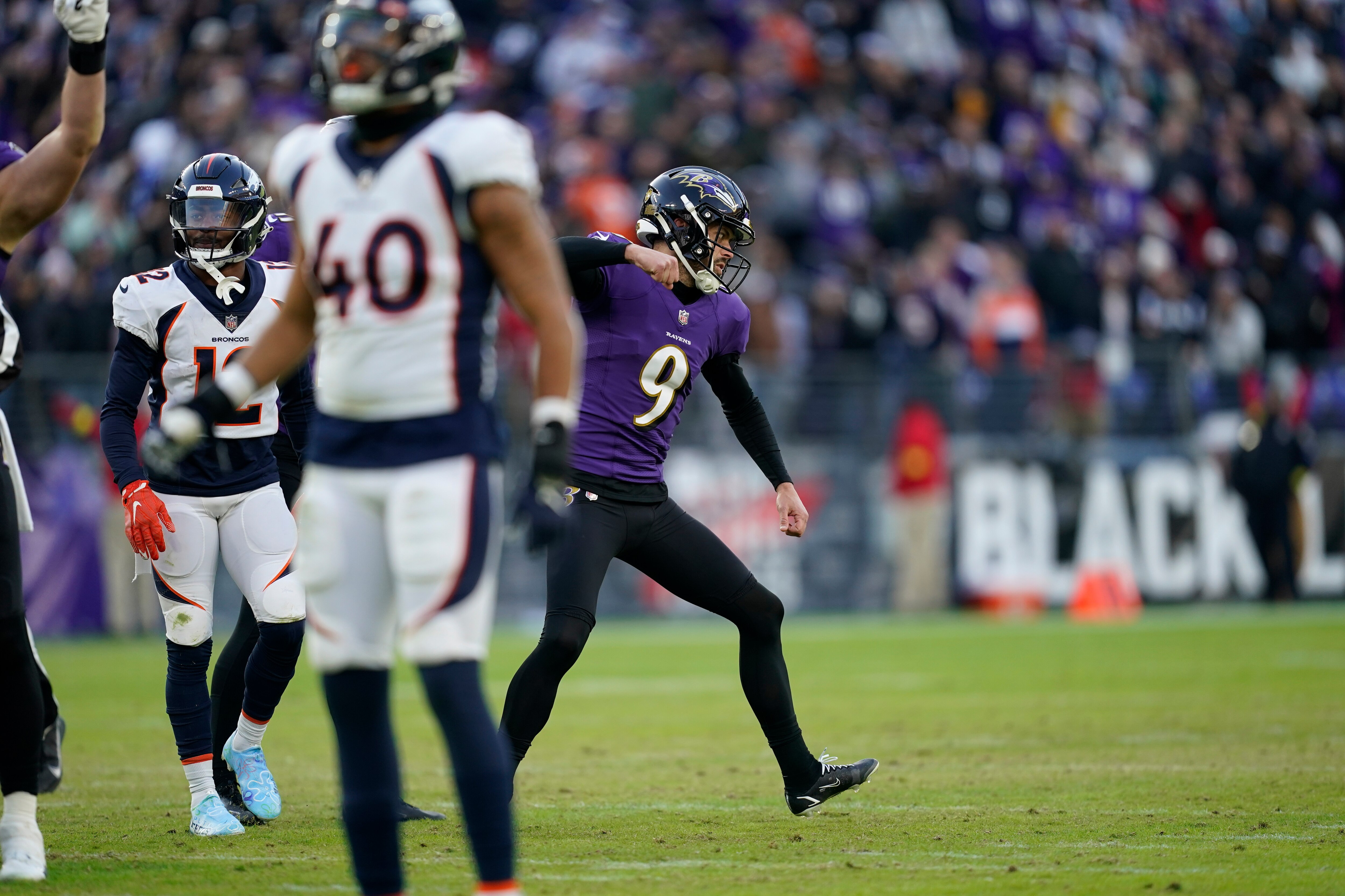 Baltimore Ravens place kicker Justin Tucker (9) celebrates after kicking the extra point to put the Ravens into the lead, in the final minute of an NFL football game against the Denver Broncos.