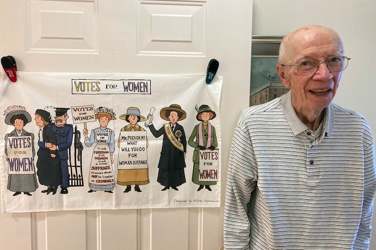John O'Hagan with a poster on his apartment door at Mercy Ridge Senior Living Community.