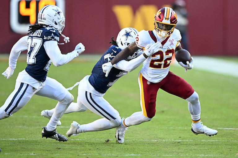 Dallas Cowbosy cornerback Trevon Diggs tackles Washington Commanders running back Jacory Croskey-Merritt in the second quarter of Week 17 of the 2025 season.