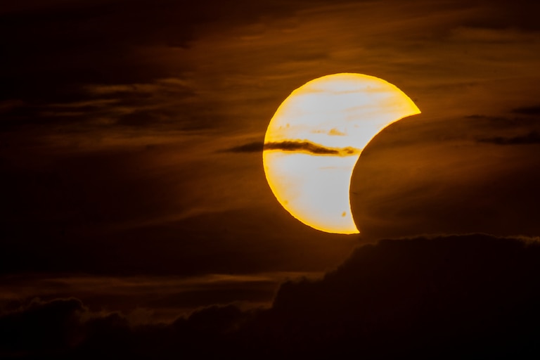 The moon partially covers the sun during a solar eclipse in Vilnius, Lithuania, Wednesday, Aug. 12, 2026. (AP Photo/Mindaugas Kulbis)