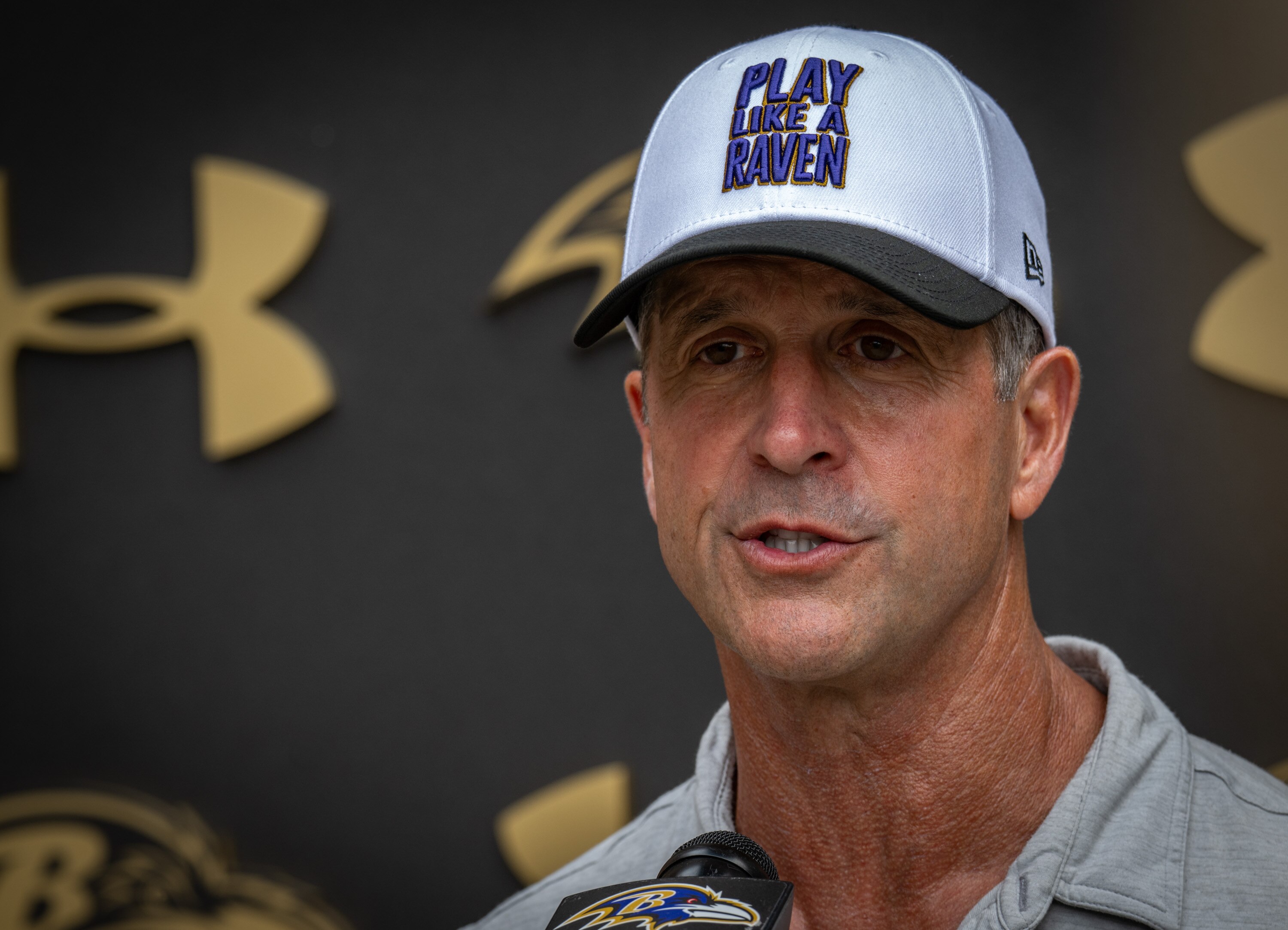 Ravens coach John Harbaugh takes questions from the media following practice on Aug. 5.