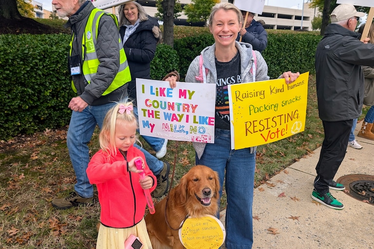 Allison Scarzini of Davidsonville brought her daughter, Zoe and their dog Gus to the protest. About 600 people walked along Generals Highway and Bestgate Road on Oct. 17, 2026.