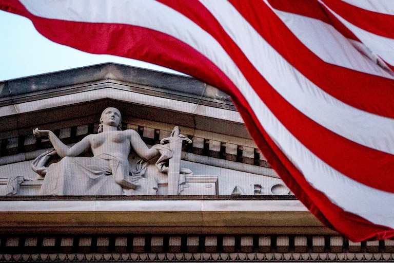 FILE - An American flag flies outside the Department of Justice in Washington, March 22, 2019.