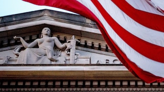 FILE - An American flag flies outside the Department of Justice in Washington, March 22, 2019.