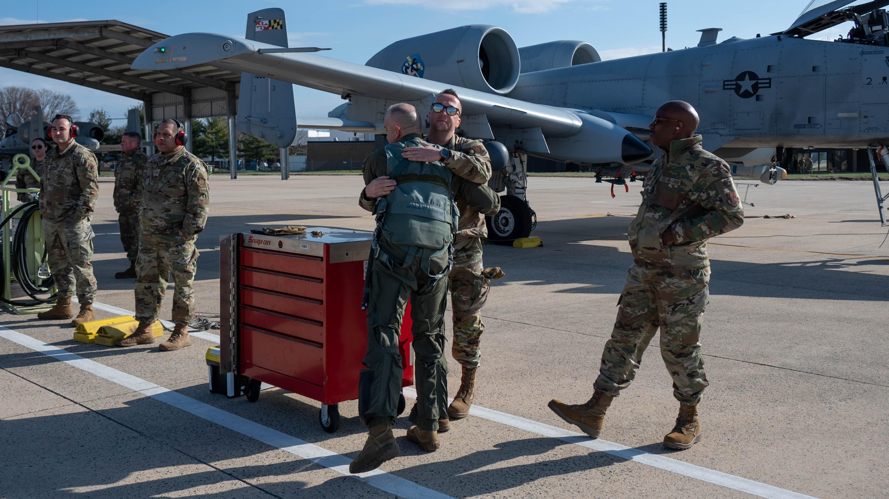 Maryland Air National Guard Lt. Col. Steven Montalvo, center, greets fellow members of the 104th Fighter Squadron March 26, 2025 at Martin State Airport before flying his A-10C Thunderbolt II to the boneyard at Davis-Monthan Air Force Base, Tucson, Arizona.