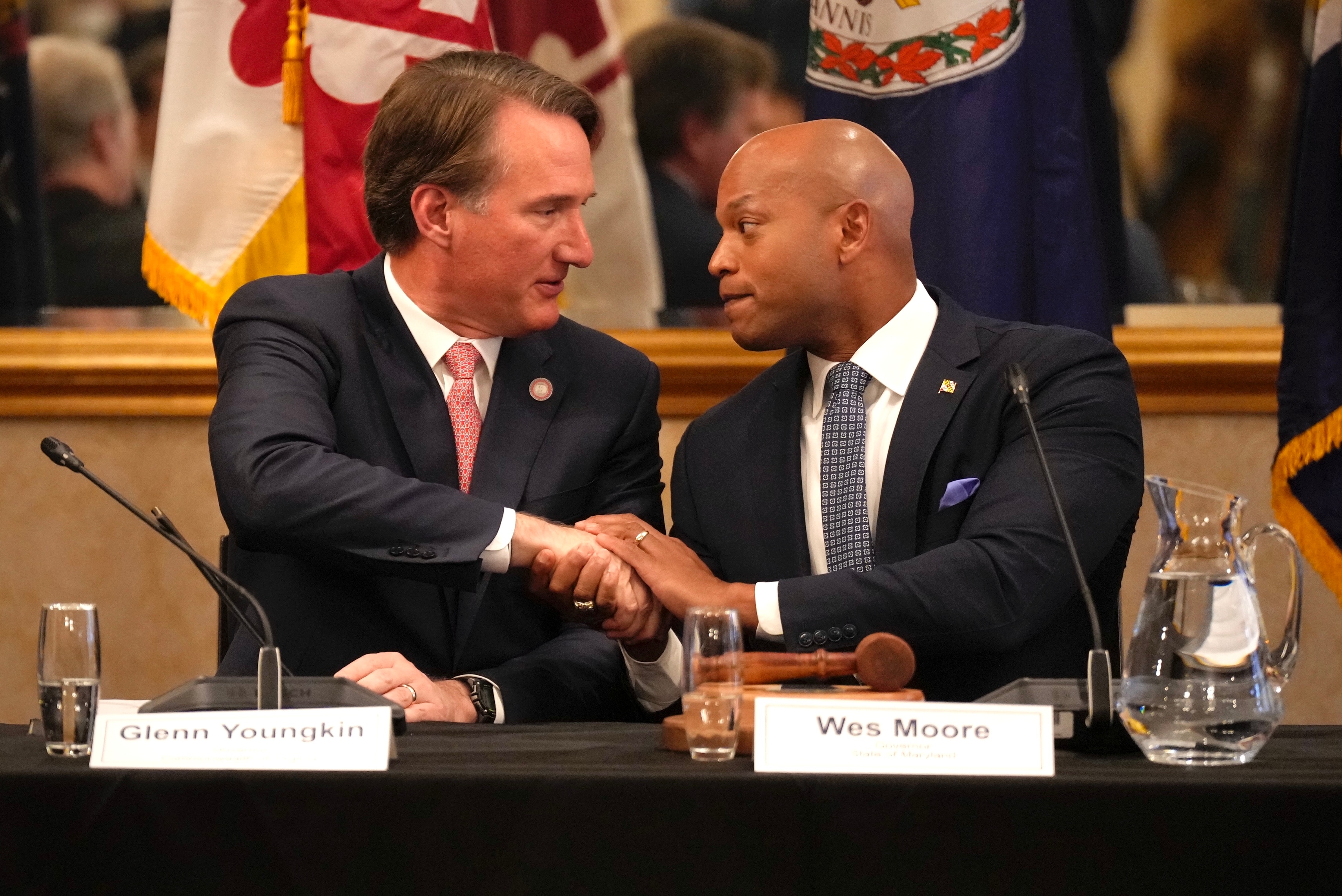 Virginia Gov. Glenn Youngkin, left, and Maryland Gov. Wes Moore shake hands during the annual meeting of the Chesapeake Executive Council in Annapolis.
