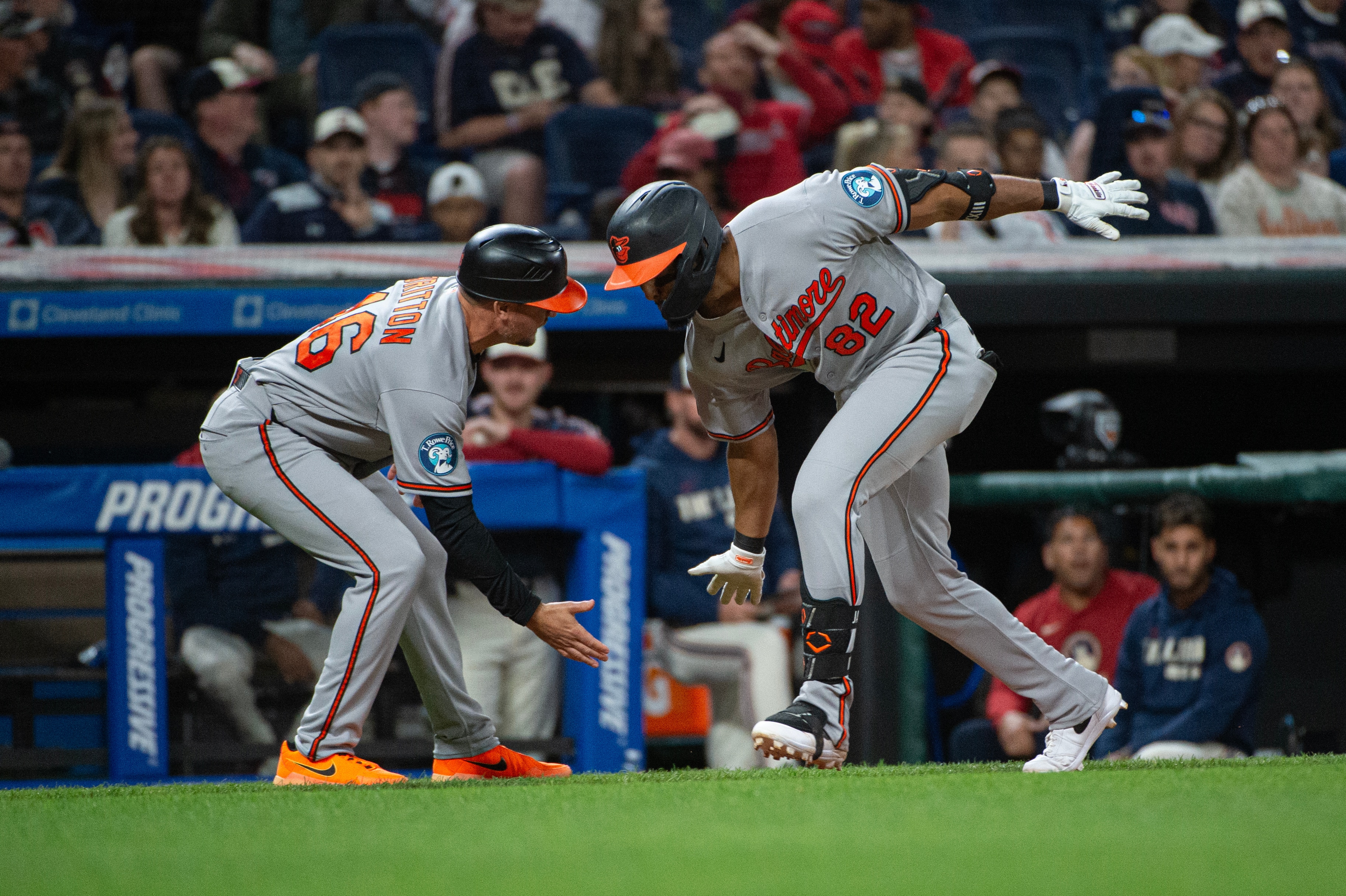 Jeremiah Jackson receives a low-five from third base coach Buck Britton on his eighth-inning home run trot.