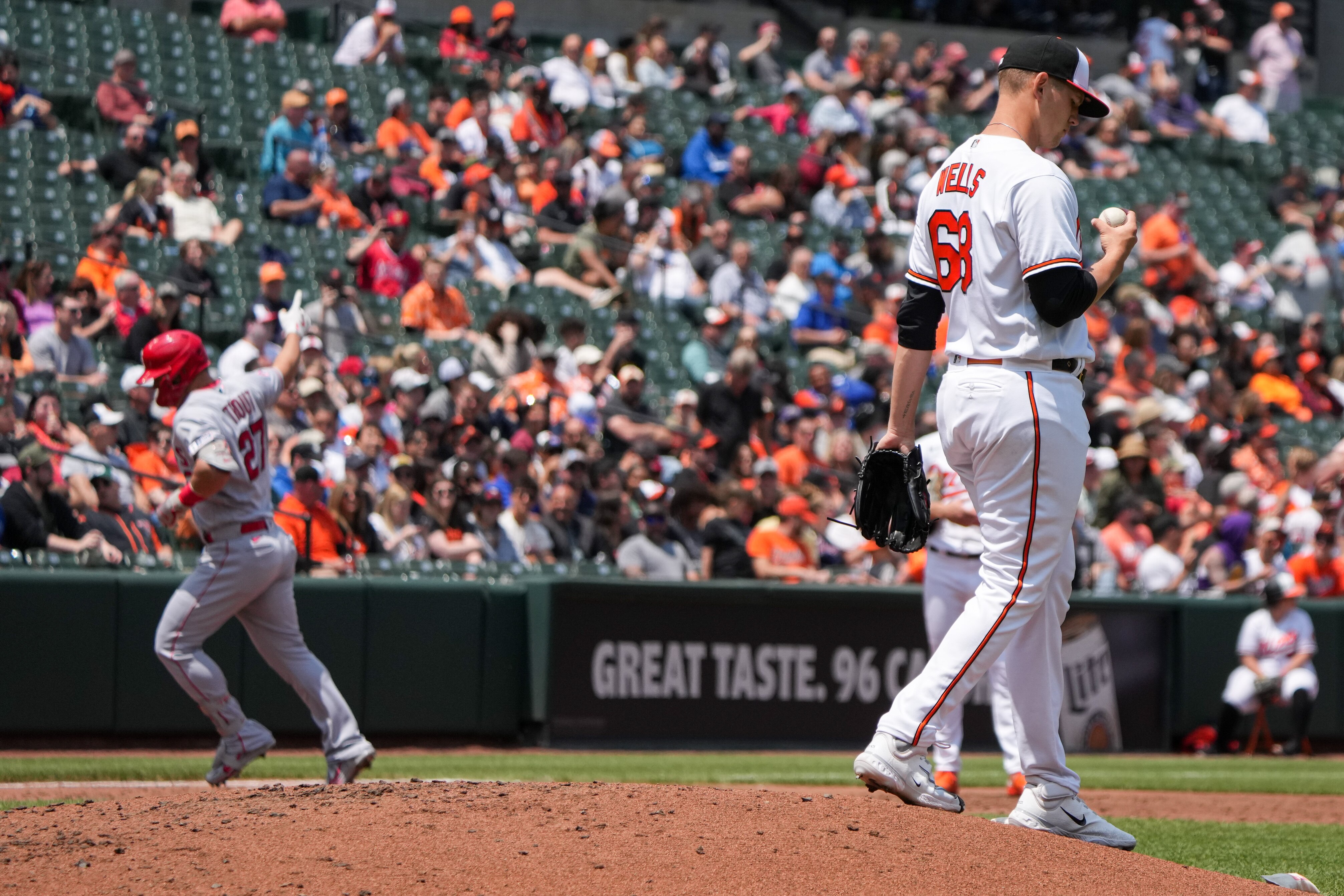 Baltimore Orioles starting pitcher Tyler Wells (68) reacts to Los Angeles Angels center fielder Mike Trout (27) rounding the bases after homering in a game at Camden Yards on Wednesday, May 17. It was the fourth game of a series in the regular season.