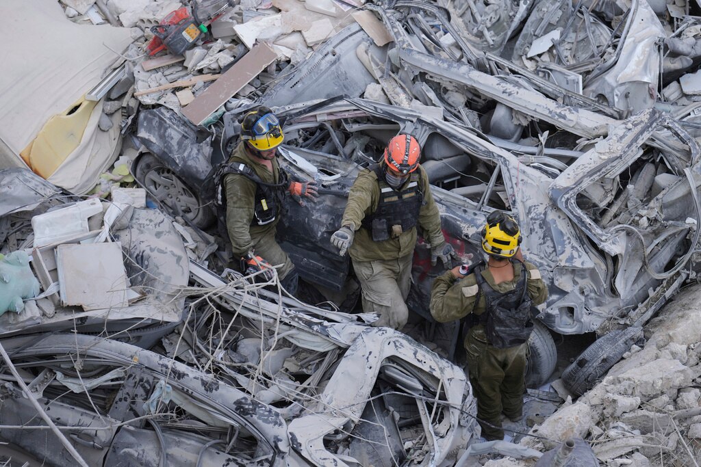 Israeli soldiers dig through rubble to search for survivors in a residential area hit by a missile fired from Iran near Tel Aviv.