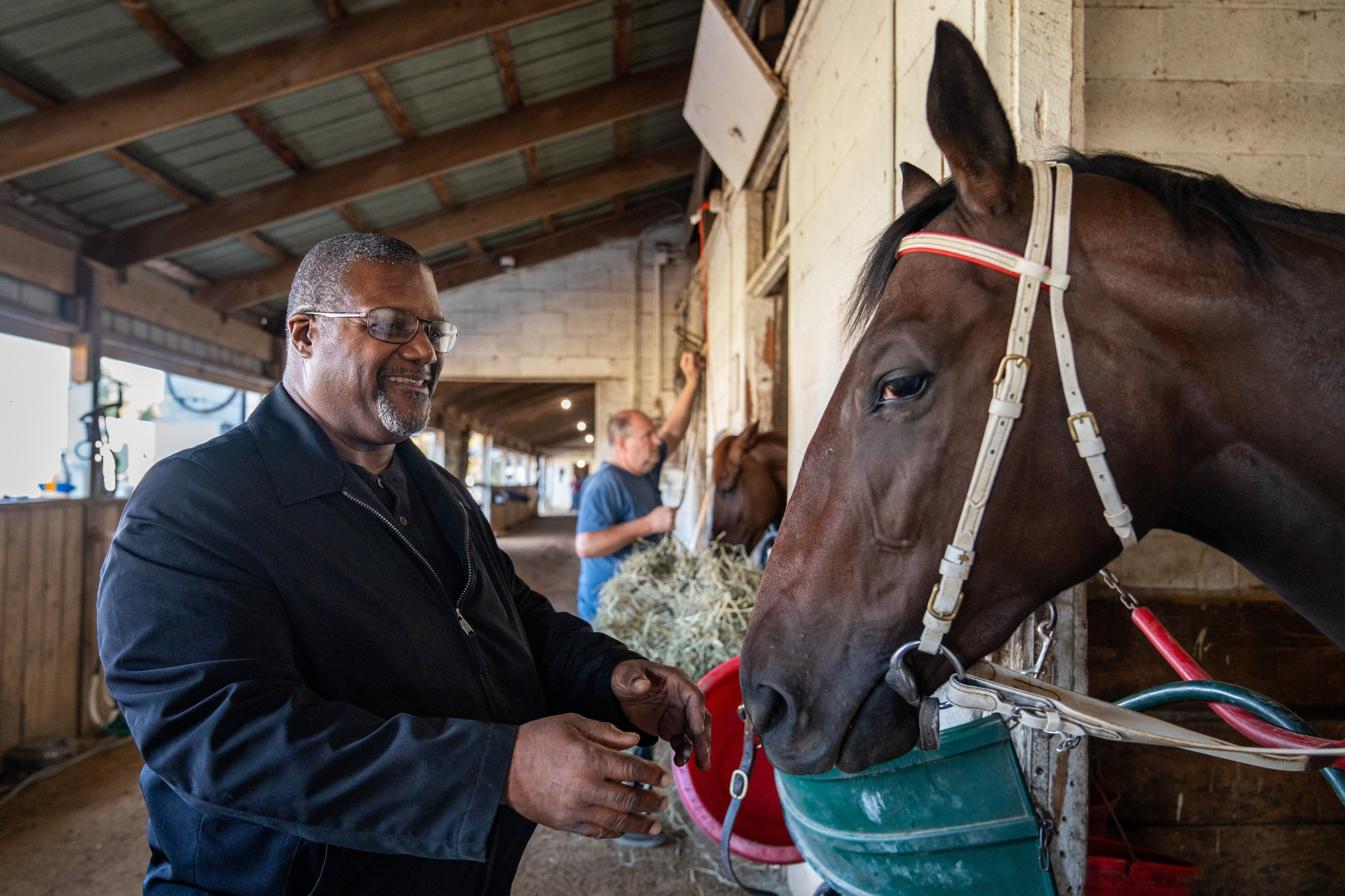 Jerome Aiken smiles and reaches out to hold Somethingwonderful.