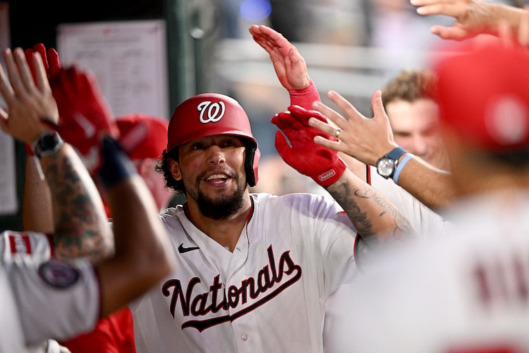 Nationals designated hitter Yohandy Morales celebrates with teammates after hitting his first career hit for a home run in the third inning of his major league debut.