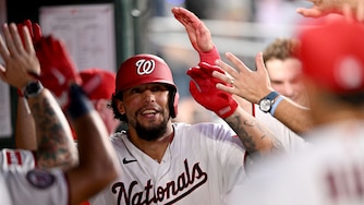 Nationals designated hitter Yohandy Morales celebrates with teammates after hitting his first career hit for a home run in the third inning of his major league debut.