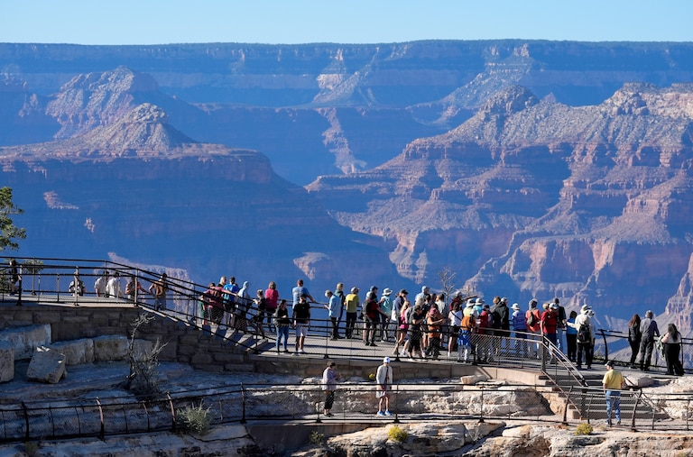 FILE - Tourists flock to Mather Point at Grand Canyon National Park, Oct. 1, 2025, in Grand Canyon, Ariz. (AP Photo/Ross D. Franklin, File)