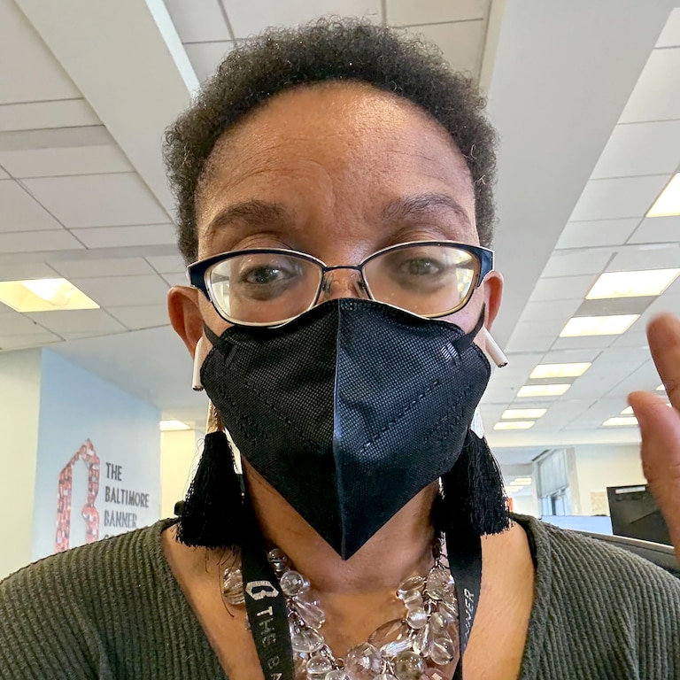 The author shows off her regular masking practice in The Banner's newsroom.