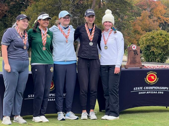 Zoe Cusack, right, after winning back-to-back individual state championship titles.